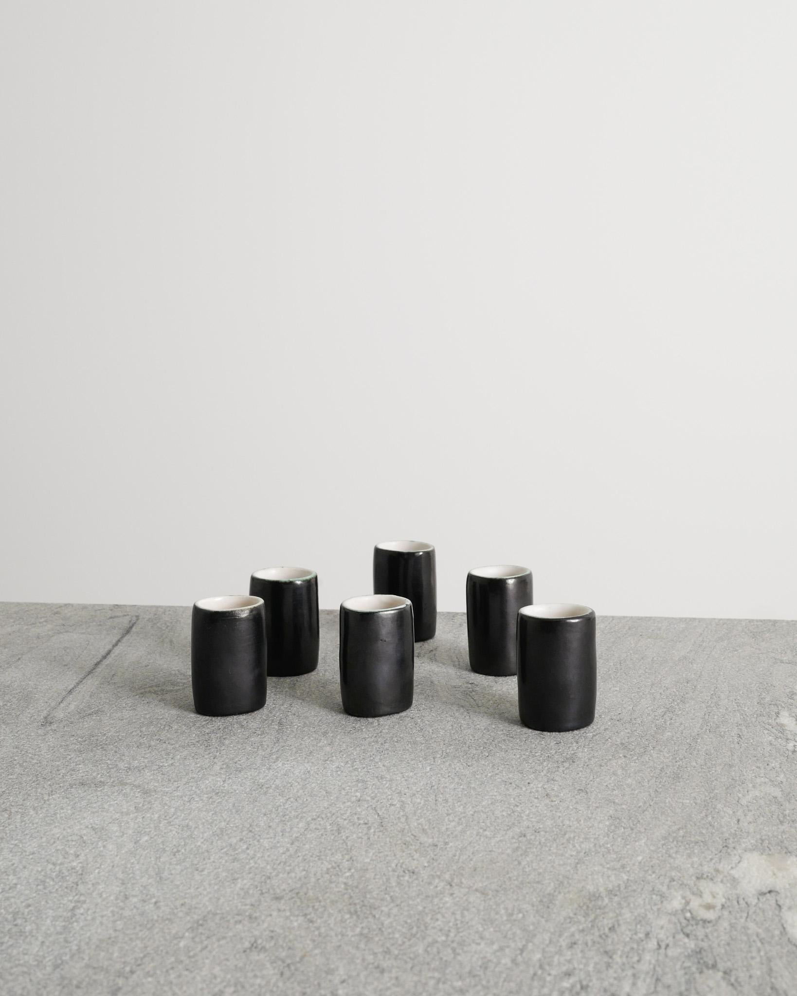 Rare ensemble de six petites tasses décoratives françaises du milieu du siècle, émaillées en noir, blanc et bleu clair, par Denise Gatard, produites en France, dans les années 1960. 
En bon état d'origine et assorti, avec une légère patine.