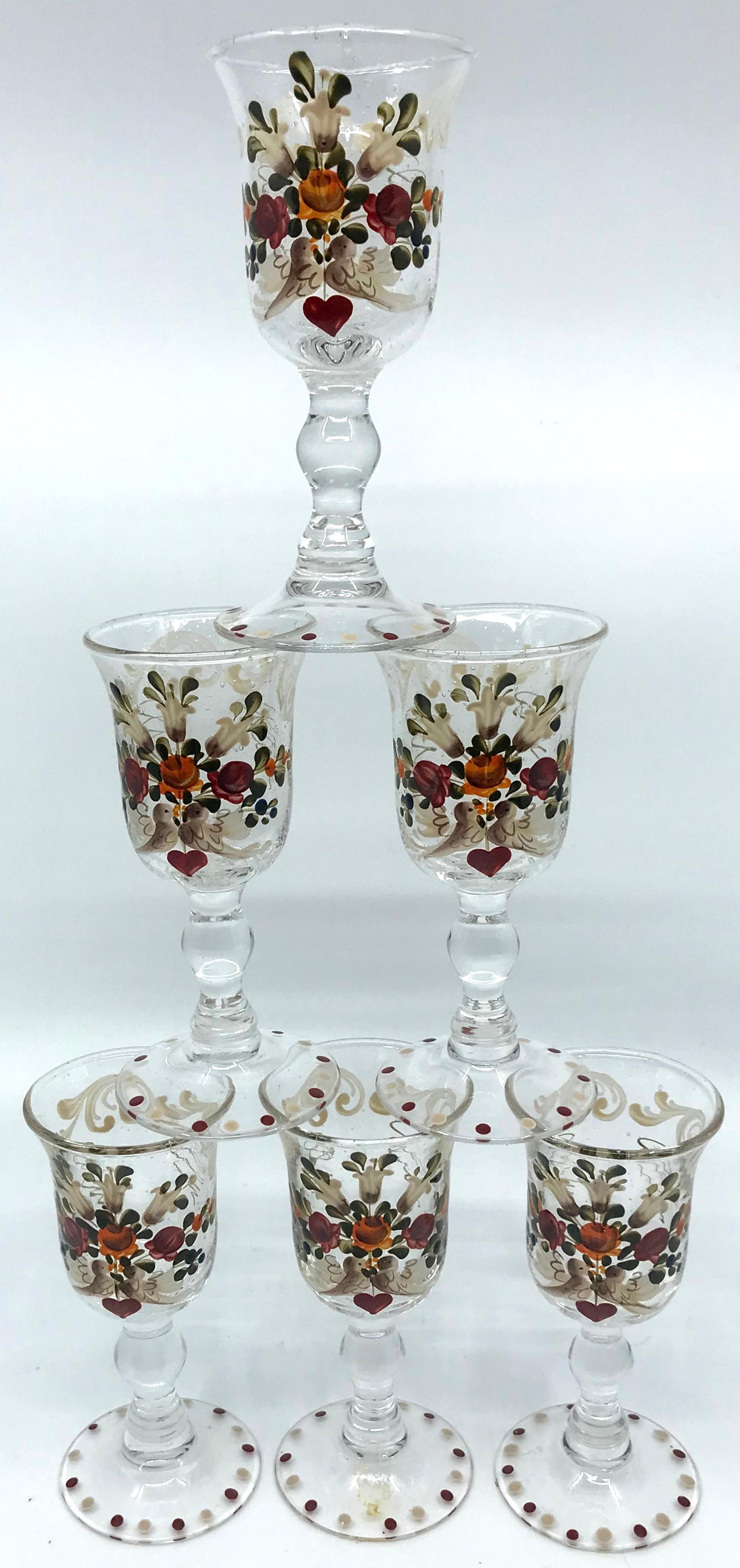 Set of six French painted glasses. Antique set of clear glass baluster form glasses with hand paint and enameled design with floral spray of lilies centered with a pair of kissing doves joined by one heart with further floral sprays and scrolls
