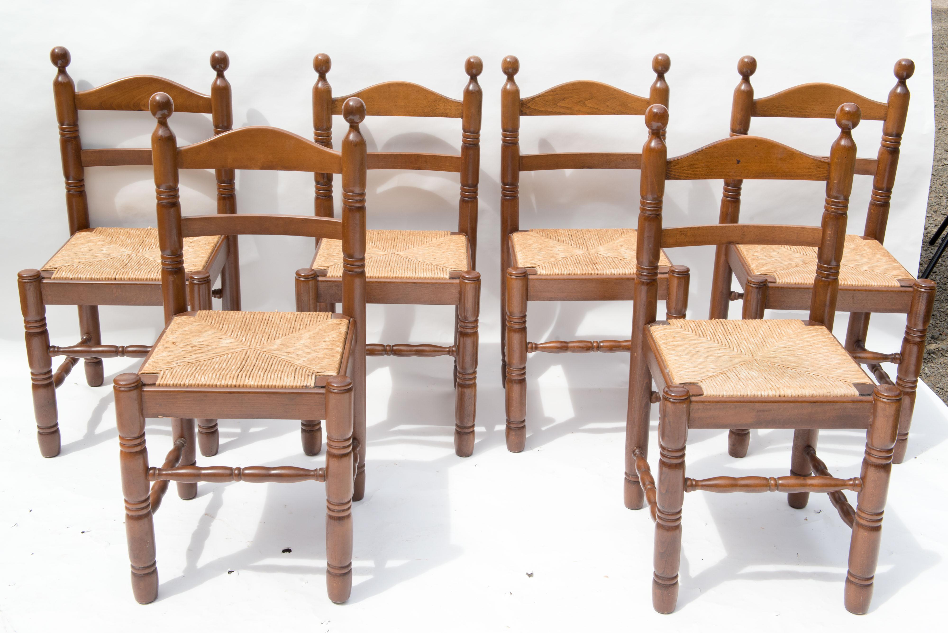Set of six French ladder back, rush seat dining chairs. Beech frames with carved turnings on stretchers, legs, and back with ball finials. We have another set of six
very similar chairs. Wood frames and rush seats are in excellent condition.