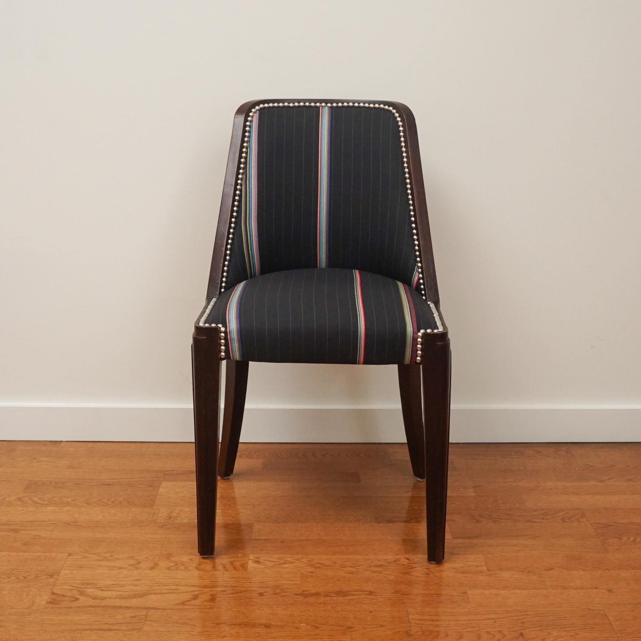 The Art Deco walnut dining chairs, shown here, are sold as a set of six. Made in the 1930s, the chair frames have been gently restored to maintain their original rich color and character. The upholstery is 