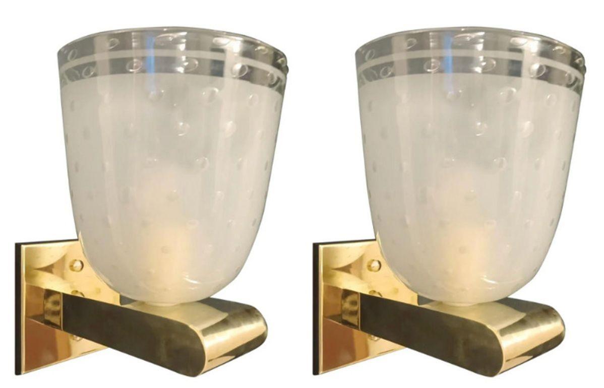 Vintage set of six Italian sconces/wall lights featuring frosted Murano glass cups, hand-blown with the Bollicine technique that creates delicate bubbles within the glass. Each sconce is mounted on a polished brass frame, highlighting the refined