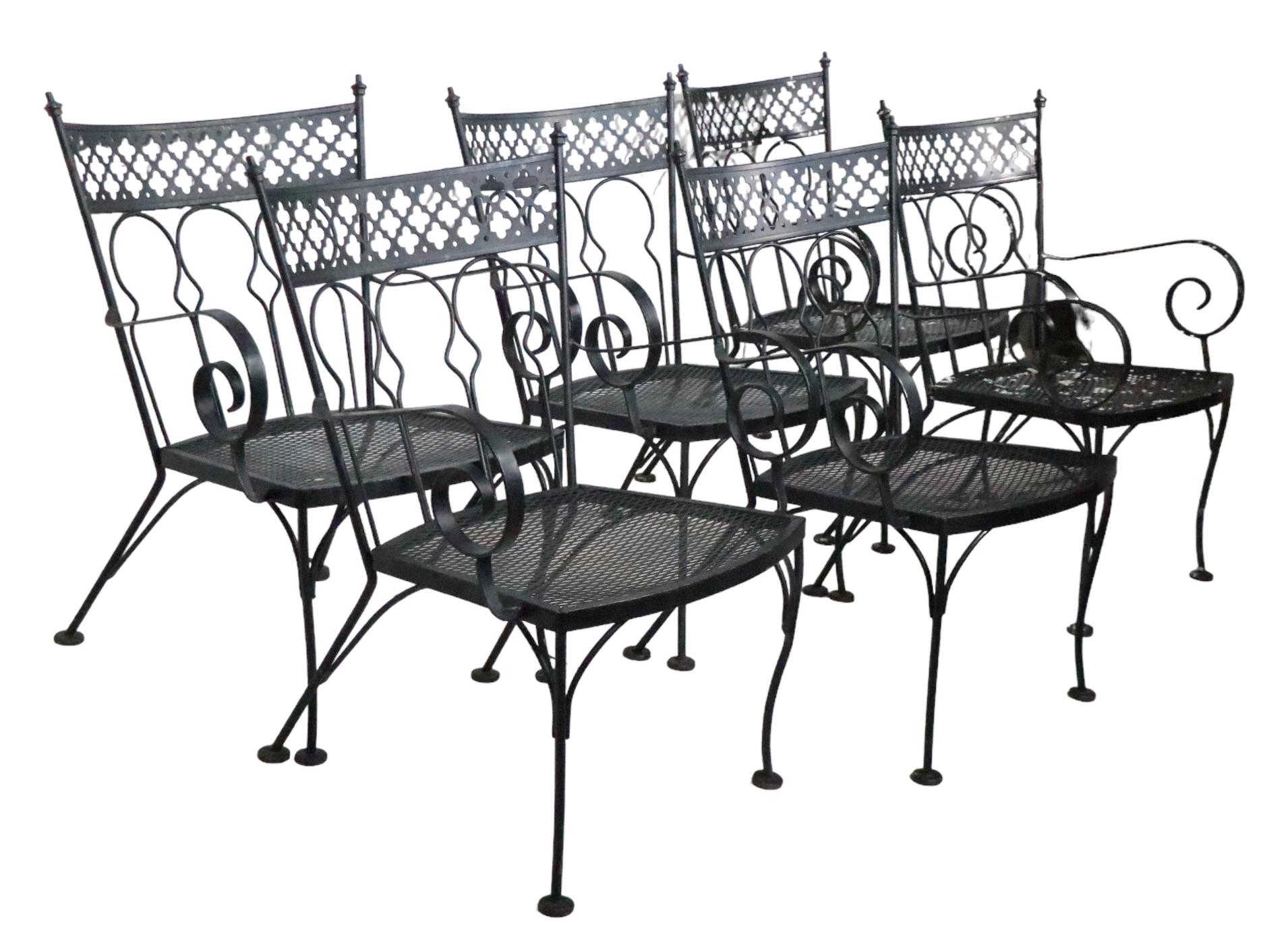 Rare set of six matching dining chairs in the sought after Taj Mahal pattern, by Salterini. The chairs feature decorative wrought iron frames and stylized back rests, with cast finials, and metal mesh seats. All are in very fine condition,