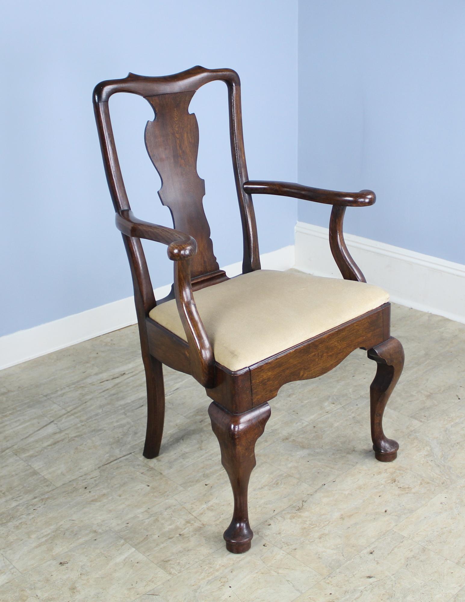 A set of four side and two armchairs made of solid oak in the George III style. Wonderful rich brown color and in very good sturdy condition. Measurement below is for the arm chairs. The side chairs measure 22