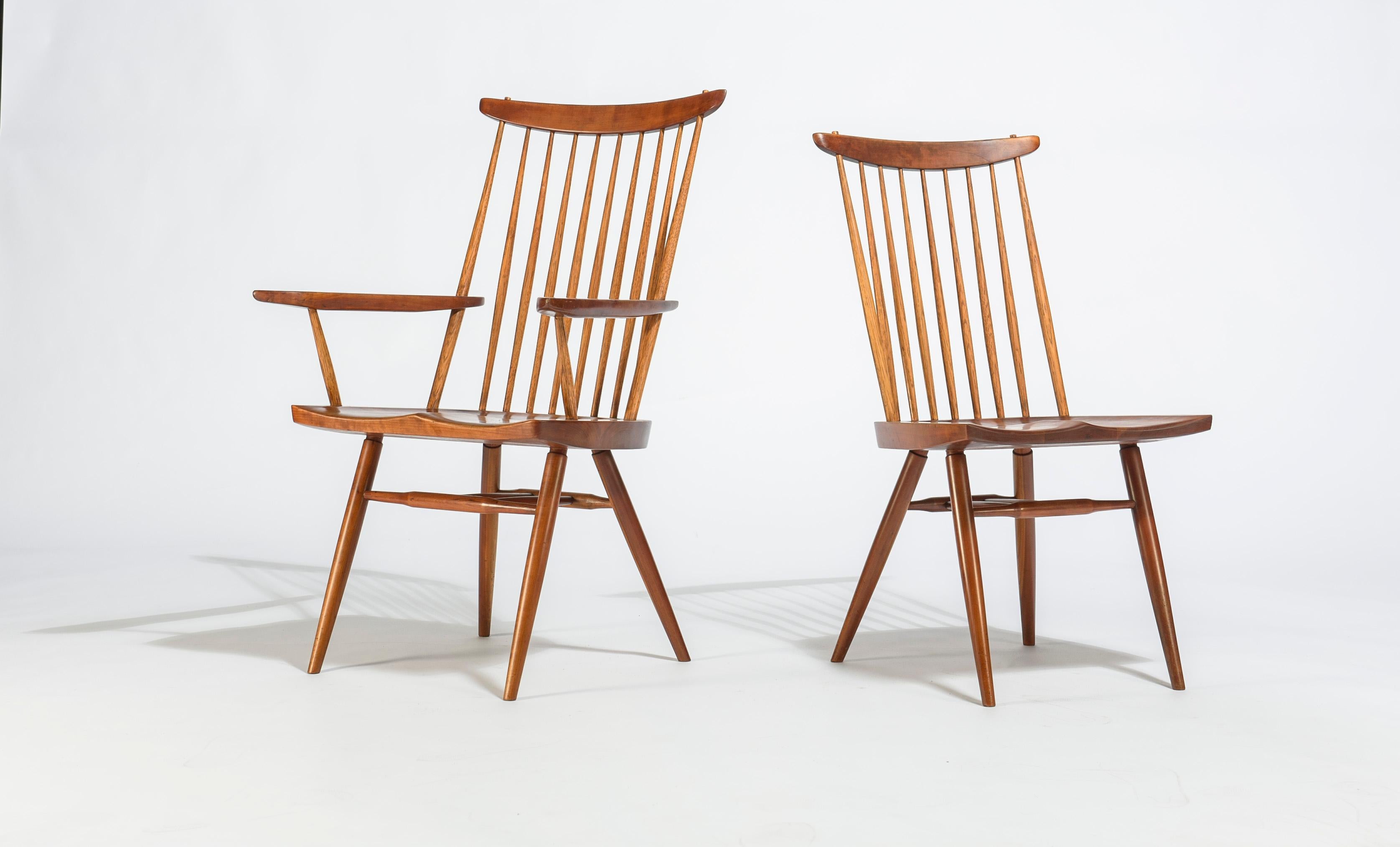 Set of six George Nakashima Cherry spindle back dining chairs. Two armchairs and four side chairs. Seats with unusual and dramatic grain.
Each signed with client name to bottom of seat.

Dimensions below for armchair. 
Side chair: 20