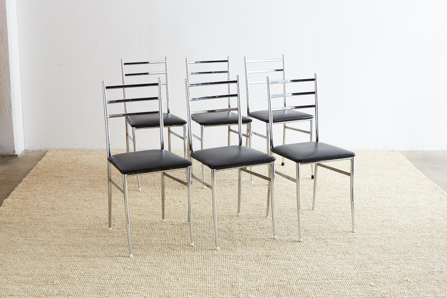 Mid-Century Modern set of six superleggera style dining chairs designed by Gio Ponti. Featuring an elegant chrome frame and a ladder back design. Fitted with black vintage vinyl upholstery. These iconic chairs have round legs that are slightly