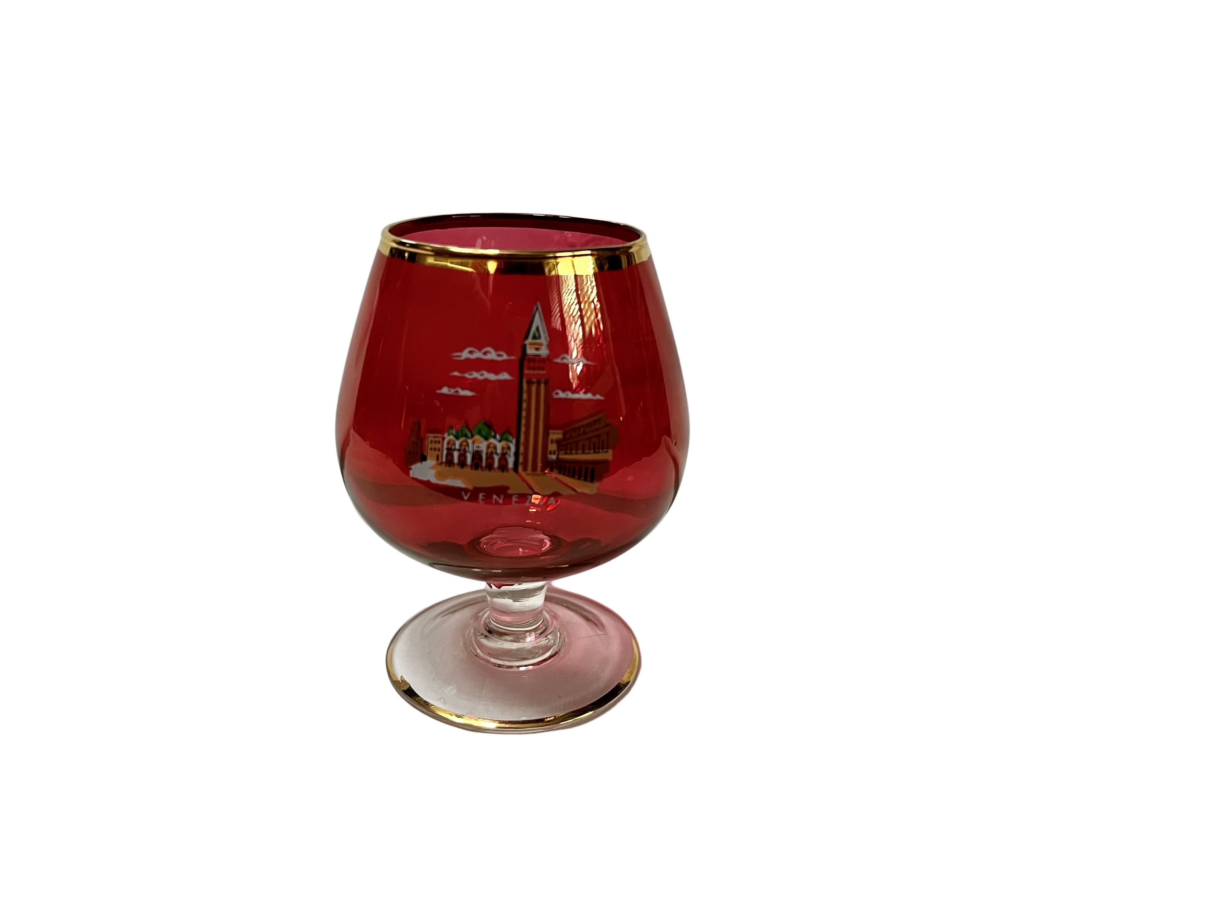 Very nice set of six glasses with the representation of the main sights of Venice, Italy. 

The cups have a base in round shape of colorless glass with a golden ring, which then merges into a bulbous shape that has a rubin red color.
The very nicely