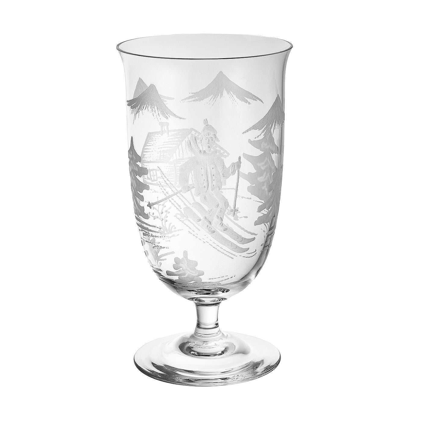 Set of six hand blown glasses in clear crystal with a hand-edged skier decor. The decor is a country style scene, showing a skier boy, trees and mountains and a chalet all-over the glass. A matching crystal carafe can be ordered in addition.