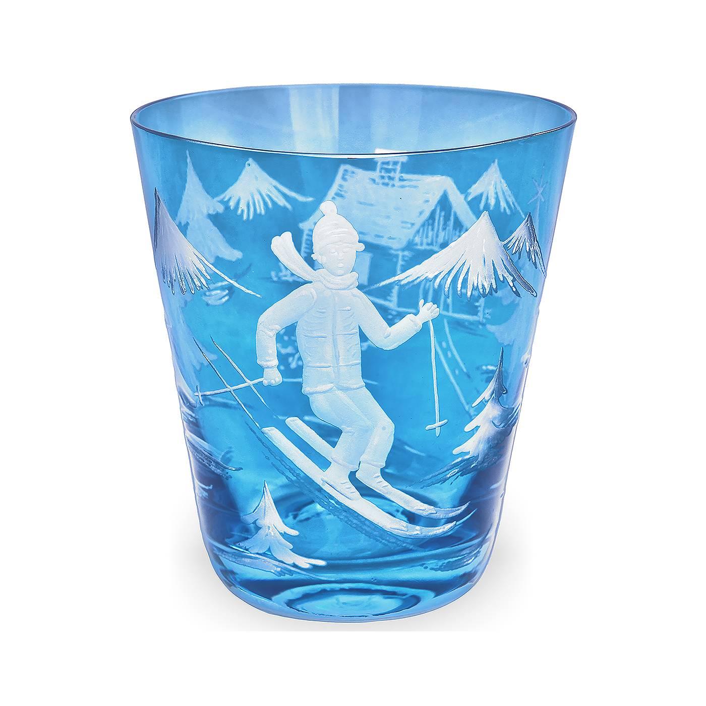 Handblown charming tumbler in blue crystal with a hands-free engraved decor. All around engraved with a coutry style decor with trees, a house and skier. A matching votiv and a carafe comes in the same decor. Signed Sofina in the bottom. Colored