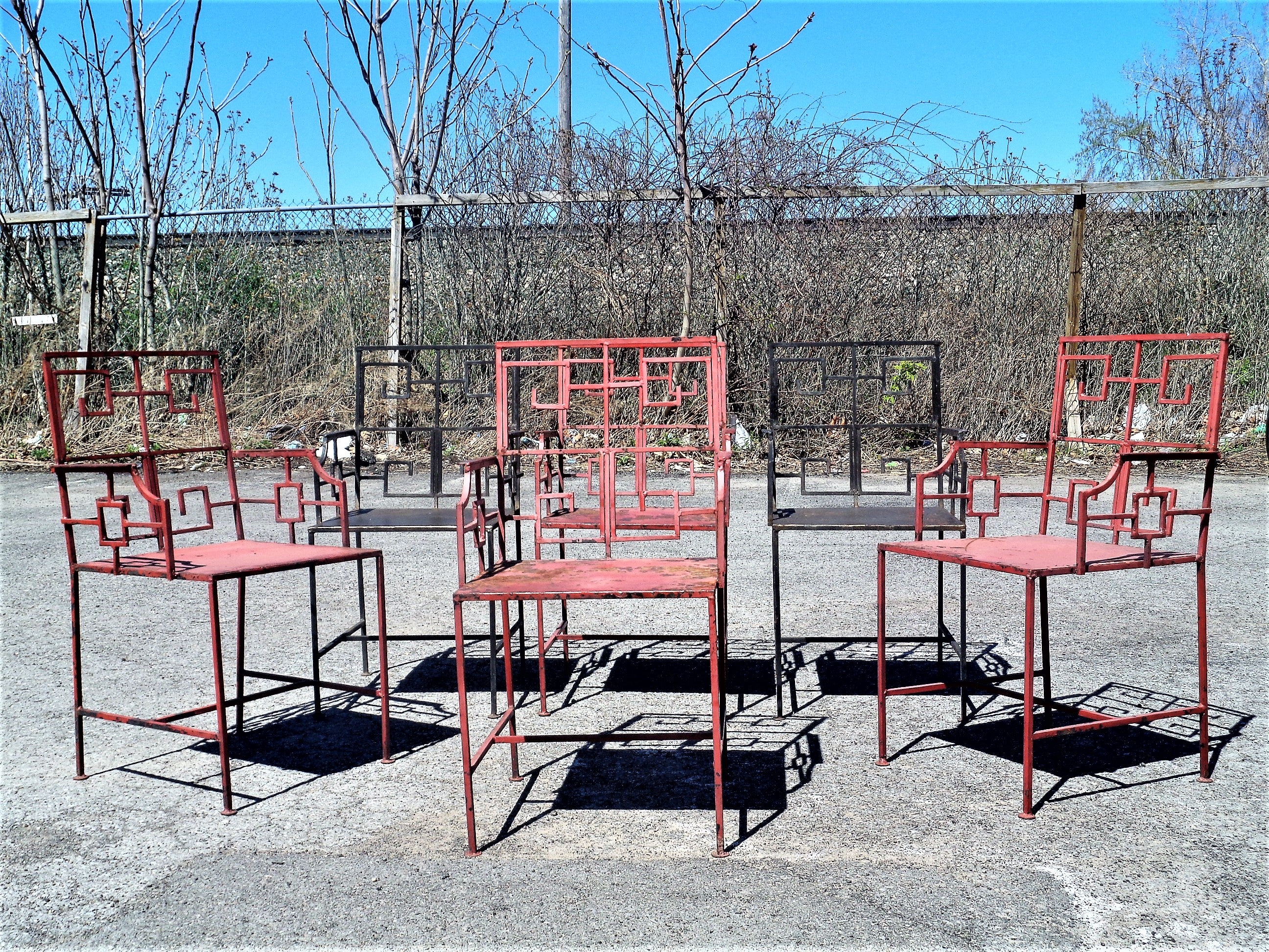 A great looking set of six hand wrought, hand welded iron armchairs in beautifully aged original old worn salmon and black painted surface ( 4 salmon / two black ) with iron seats and greek key design at backs and arms. Circa 1940's. Look at all