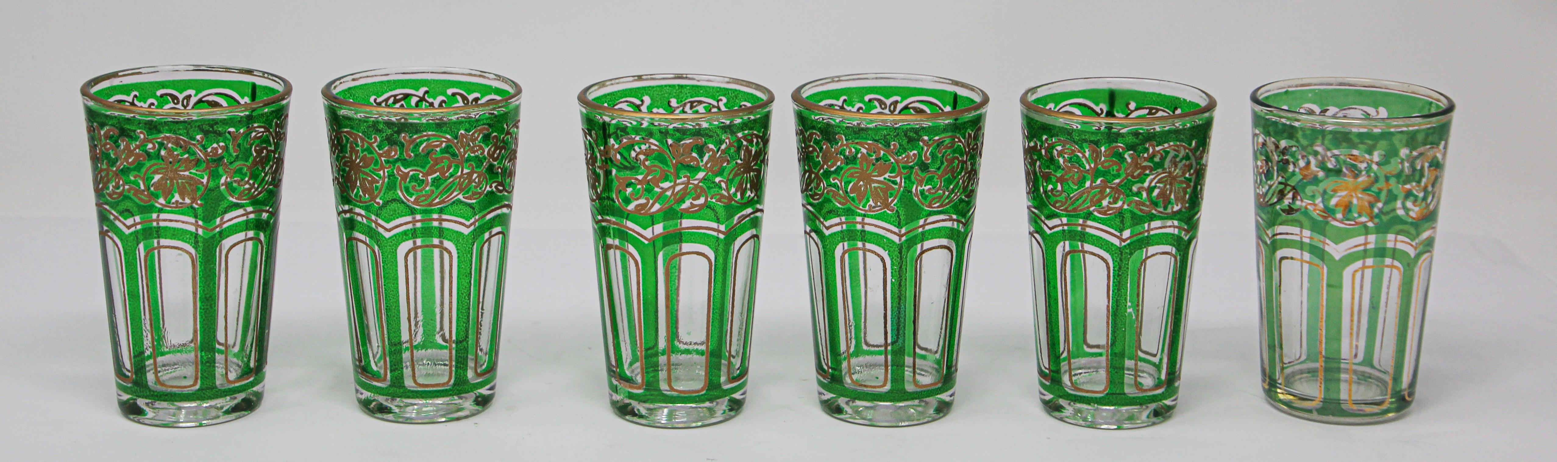 Set of six Moroccan emerald green glasses with gold raised Moorish design.
Decorated with a classical gold and pattern Moorish frieze. 
Use these elegant vintage glasses for Moroccan tea, or any hot or cold drink.
Perfect for the holidays and