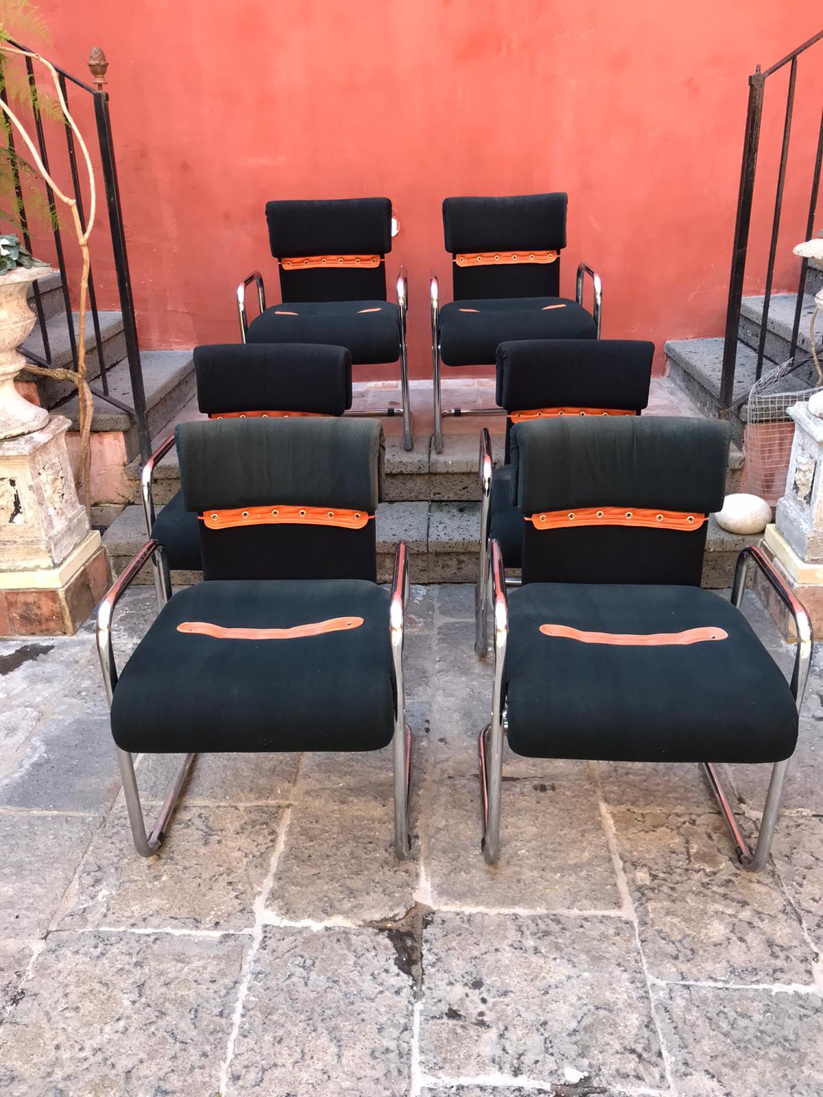 A stylish set of six chairs designed by Guido Faleschini for Mariani are an iconic 1970s vintage seats.
Sleek lightweight chromed tubular steel frame and black colour  fabric  with braided detailing on the backrests and seats. 
They are in very good