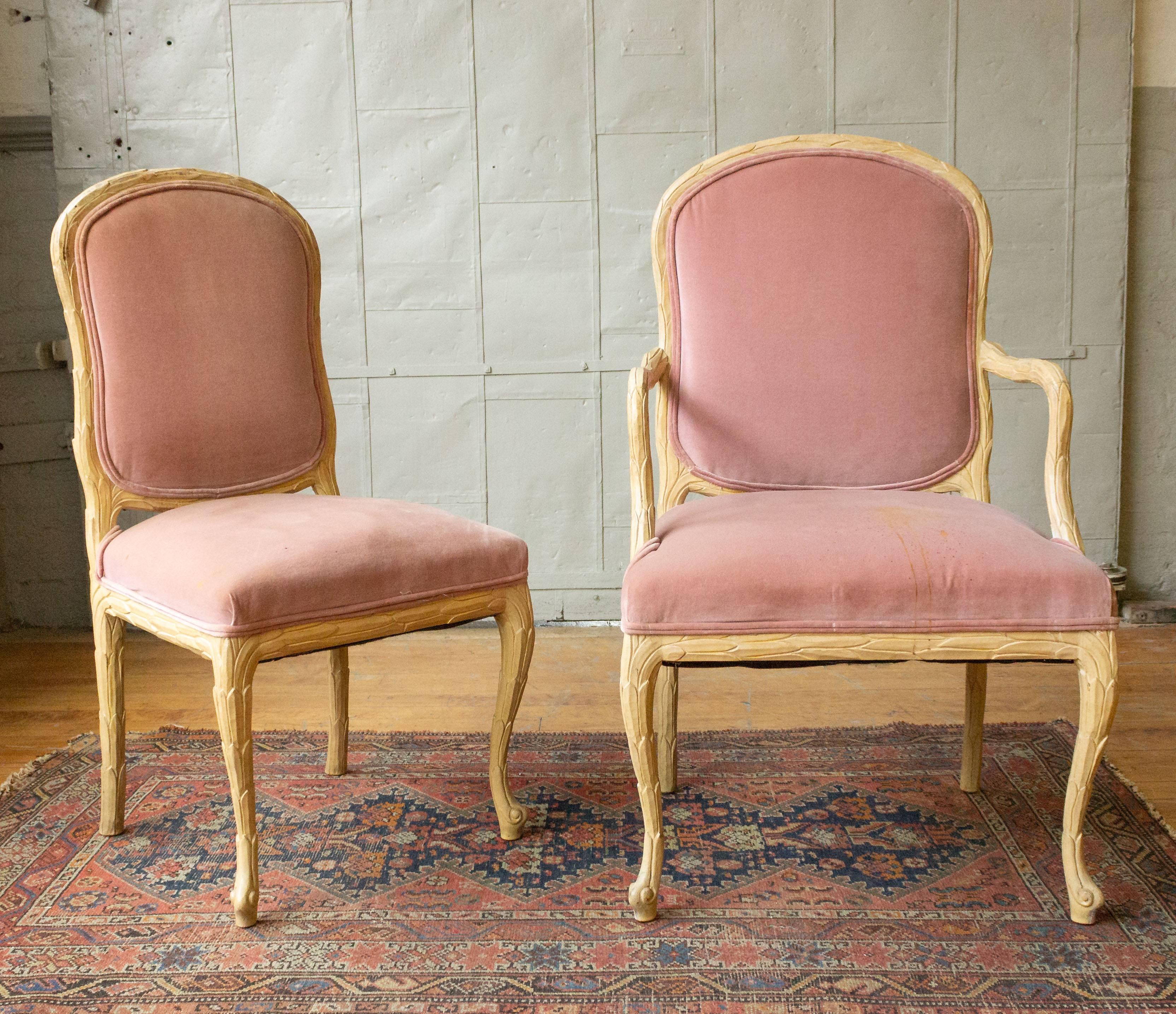 Set of six hand-carved dining chairs (two armchairs and four without arms). Frames have carved overlapping leaves in a light, natural wood. Back and seat cushions are pink and need to be reupholstered. Not only unique but also very
