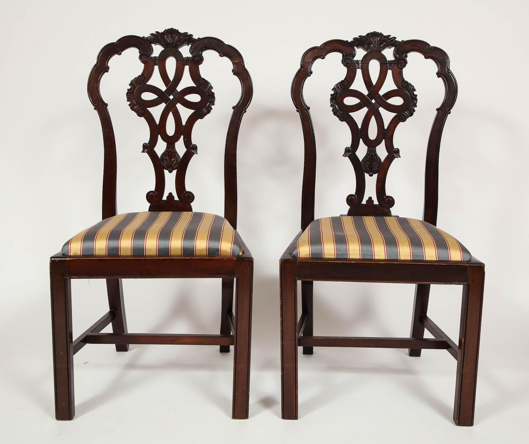 A beautiful set of six hand-carved antique English Chippendale mahogany dining chairs, after the famous Thomas Chippendale. These six beautiful hand-carved mahogany chairs exuberate class and luxury. The naturally dark wood has been magnificently