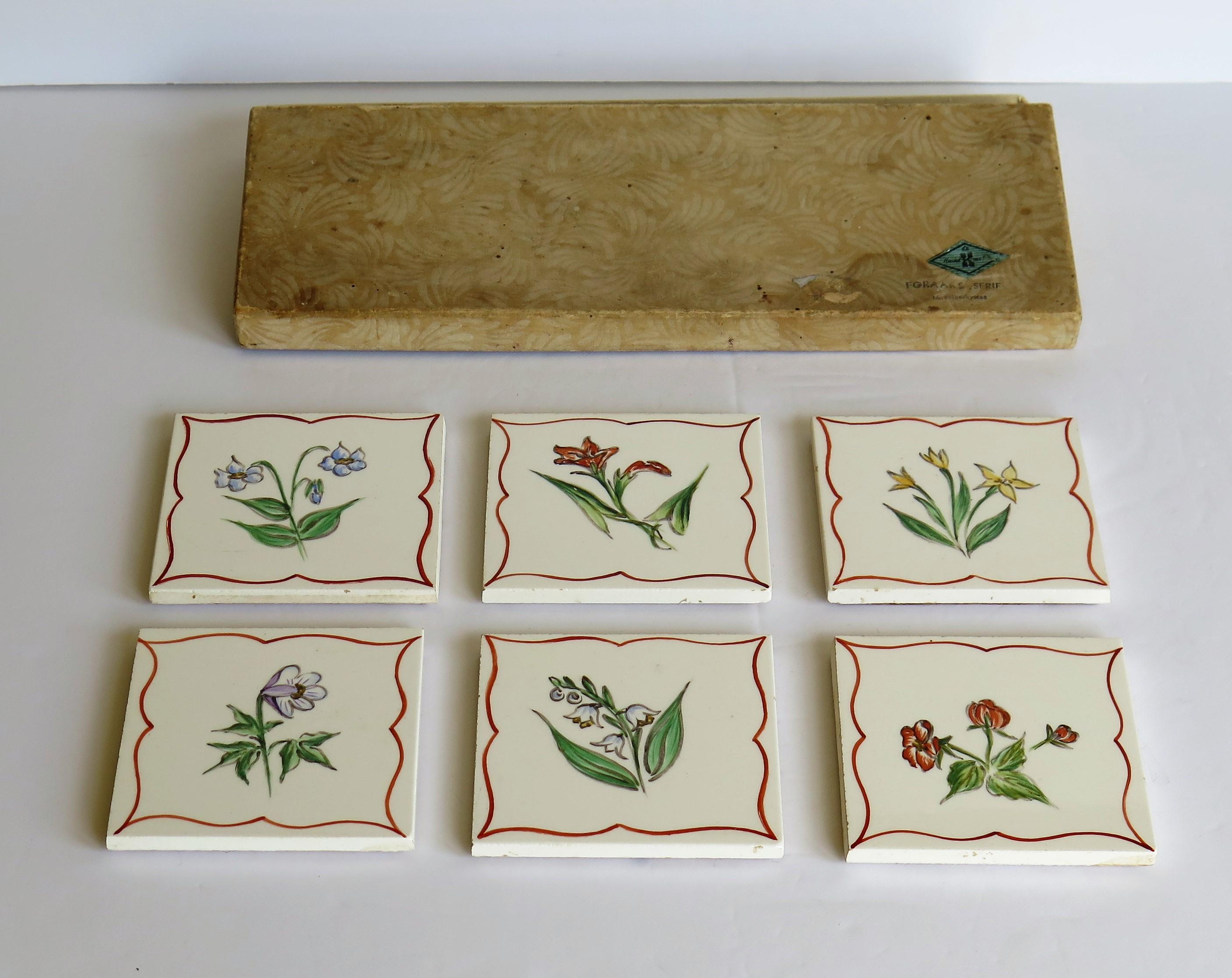 These are a good set of Six ceramic tile coasters, all hand painted with a different flower, designed by Kaj Polk and made in Denmark, complete with their original box.

Each tile or tile coaster is nominally 3 inches square and cork