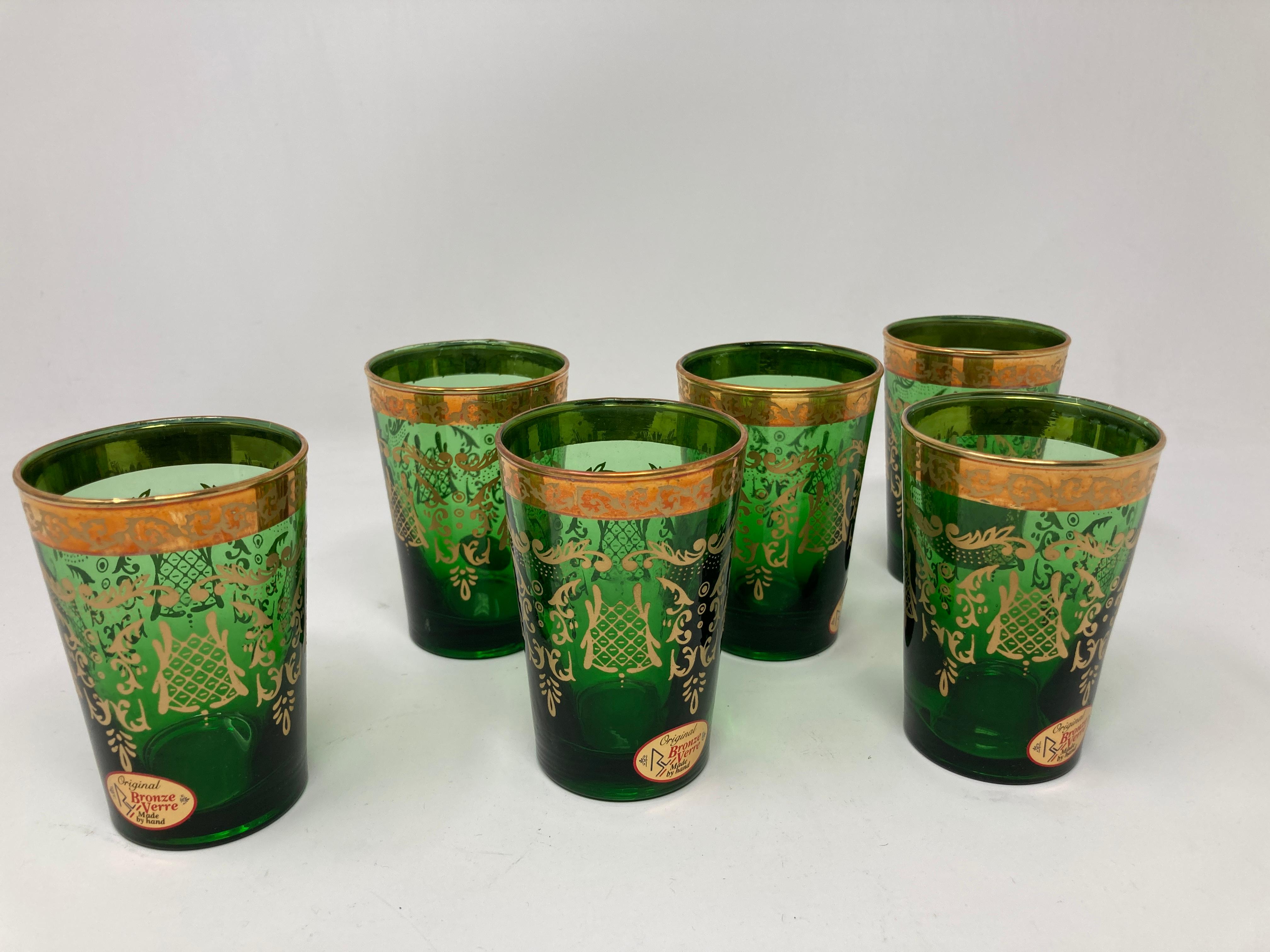 Set of six green and gold handblown Moorish tea glasses.
Use them for Moroccan tea, or any hot or cold drink.
Shot glasses very light finely decorated with a classical 22 karat gold Moorish pattern frieze.
Use these elegant glasses for Moroccan tea,
