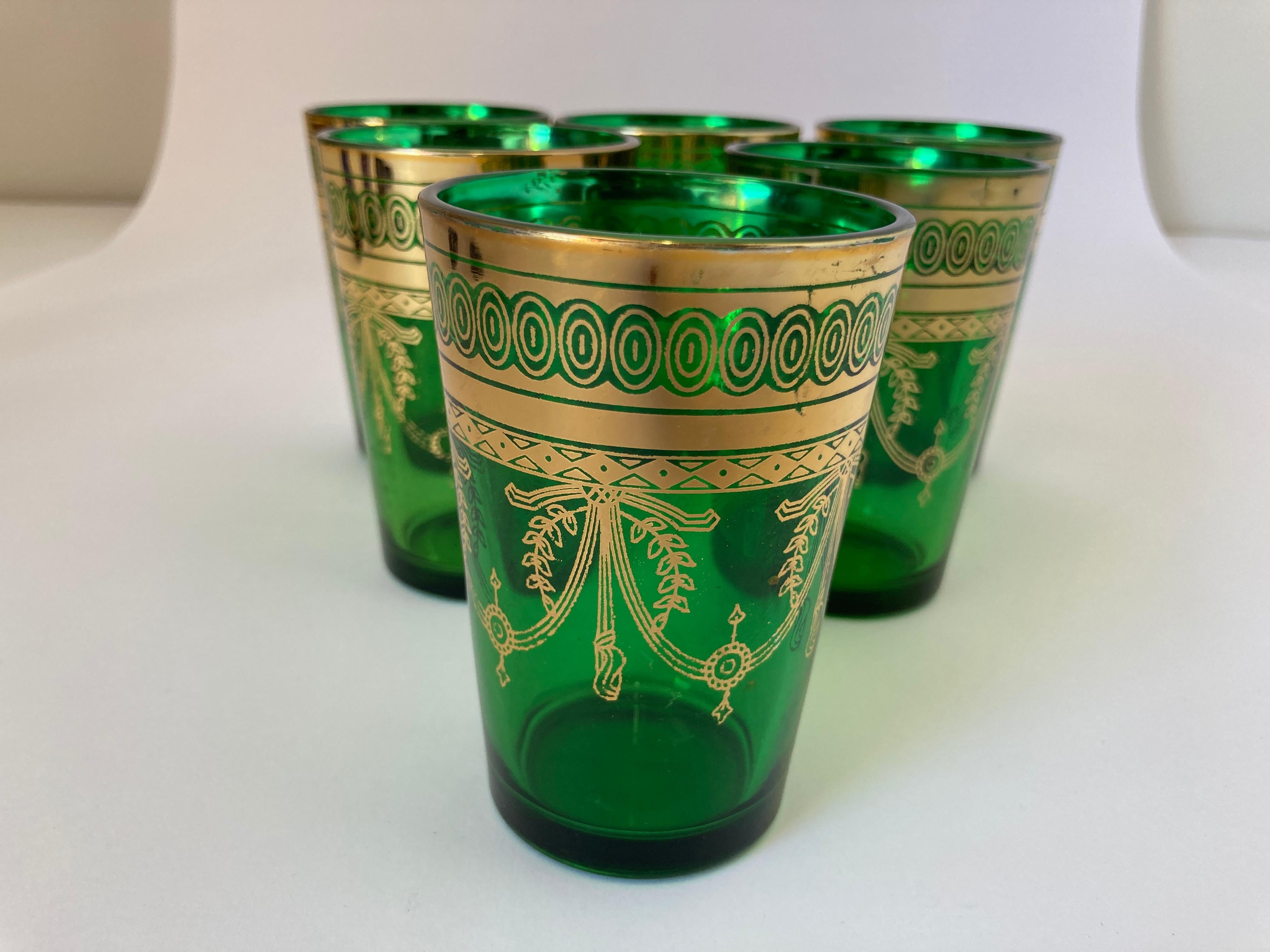 Set of six green and gd handblown Moroccan Moorish glasses.Use them for Moroccan tea, or any hot or cd drink.Shot glasses very light finely decorated with a classical 22 karat gd Moorish pattern frieze. Use these elegant glasses for Moroccan tea,