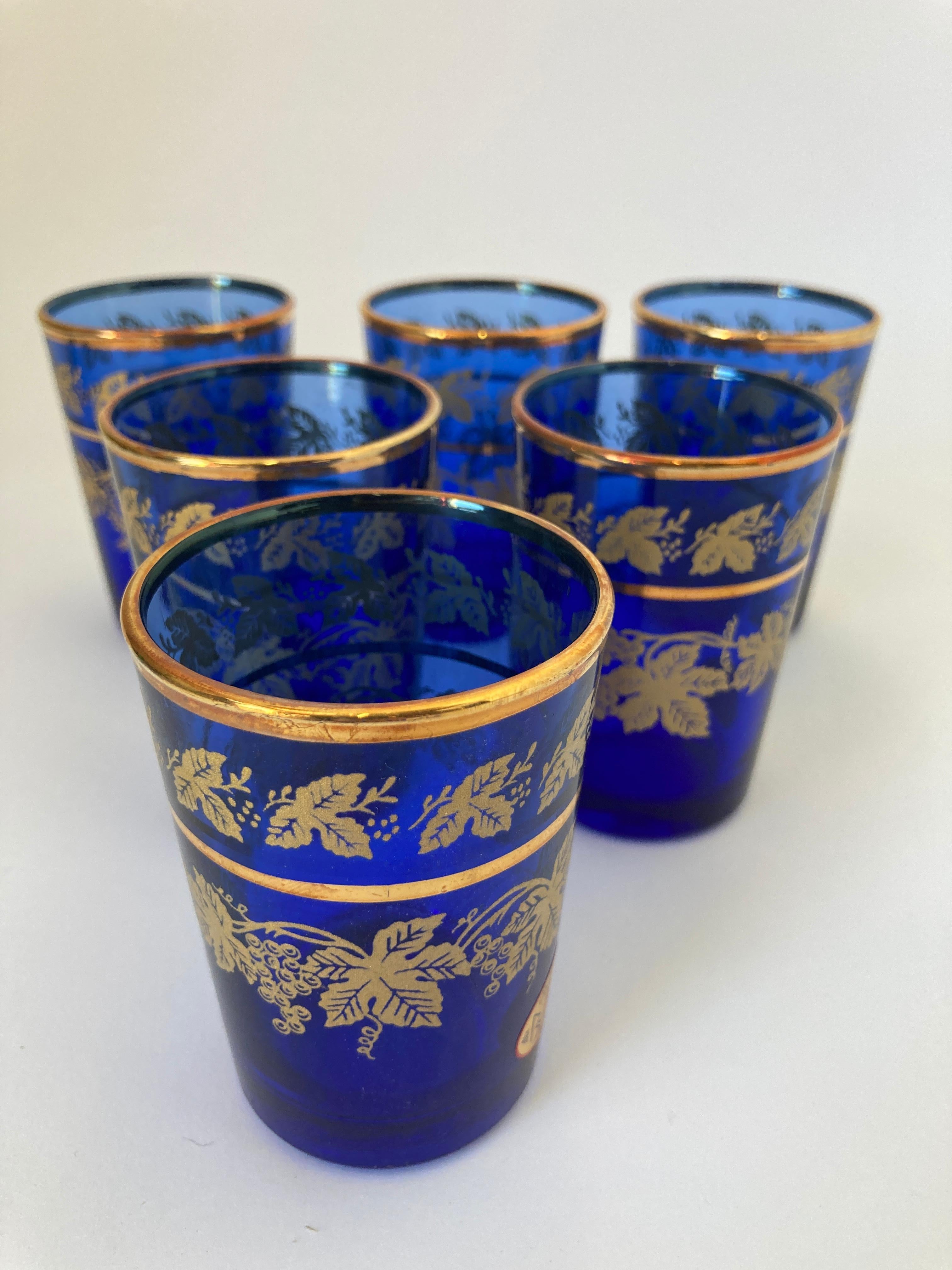 Set of six royal blue and gold handblown Moorish glasses.
Use them for Moroccan tea, or any hot or cold drink.
Shot glasses very light finely decorated with a classical gold pattern frieze. 
Use these elegant glasses for Moroccan tea, or any hot or