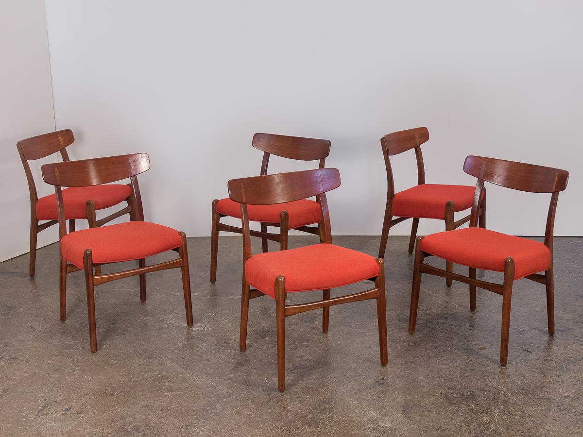 Set of six original Hans J. Wegner Ch-23 dining chairs from the 1950s. Deceptively simple at first glance, the chairs are constructed with elegant details including the fine cruciform cap joinery exposed on the curving backrests. A clean,
