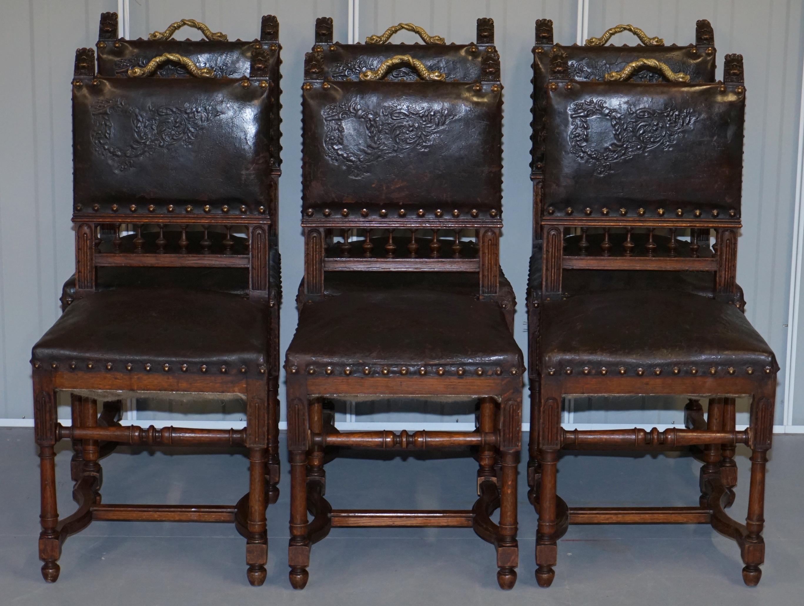 We are delighted to offer for sale this exceptional set of six French oak with Embossed pressed brown leather upholster Henry II circa 1880 dining chairs with bronze dolphin handles

A very rare and totally original set of Victorian dining chairs.