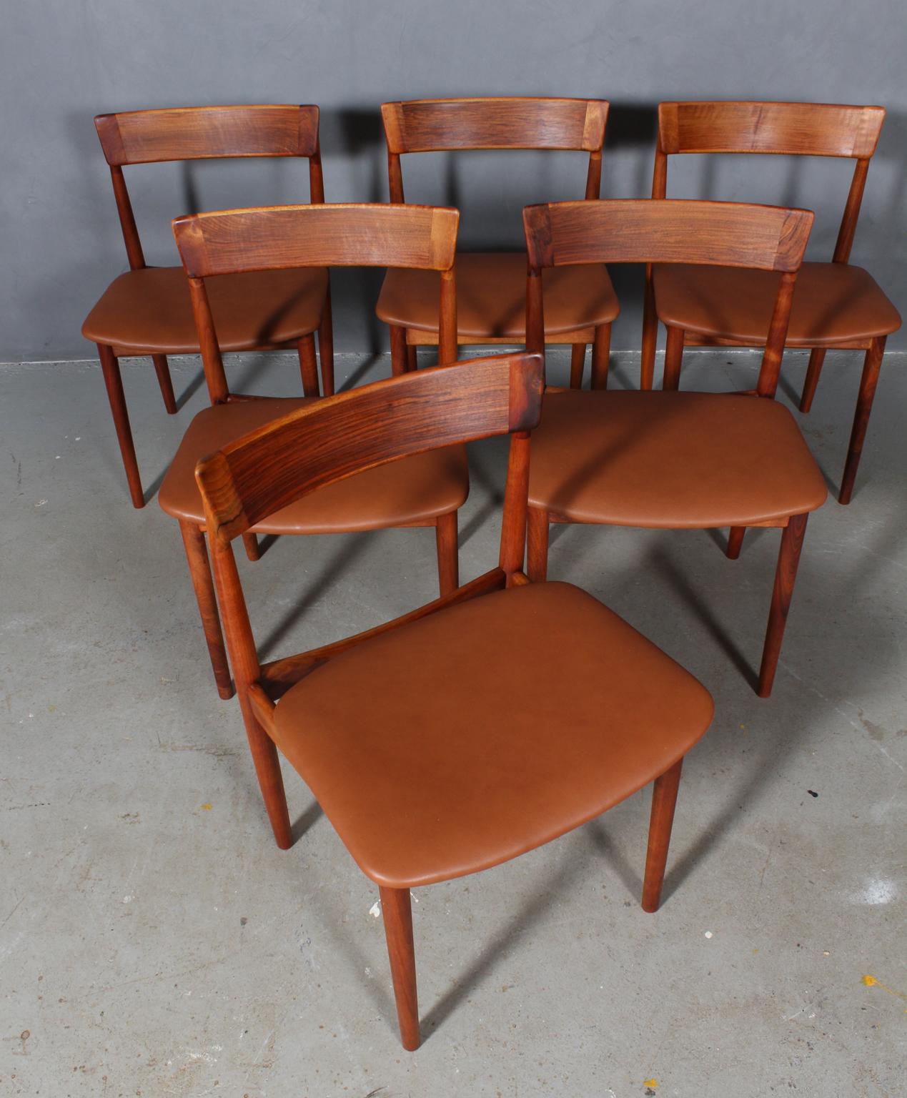 Set of six Henry Rosengren Hansen dining chairs, frame of partly solid nut with great details.

Seat new upholstered with tan pure aniline leather.

Made by Brande Møbelindustri.