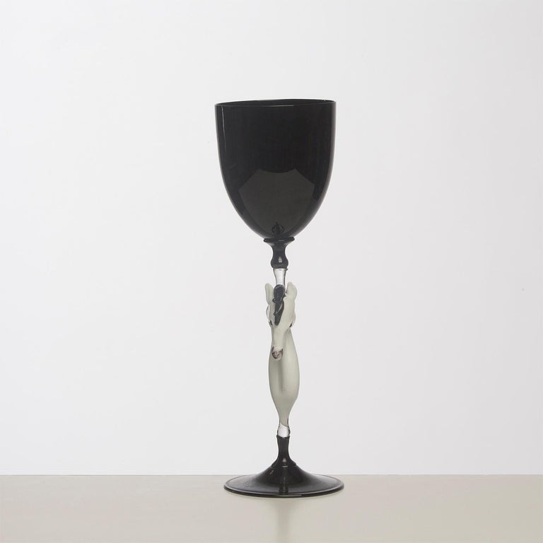 Exquisite set of 4 wine glasses handcrafted in Murano by the famous Venetian glass master Dario Frare. Executed using the traditional blowing technique, these are elegant pieces in signature glossy black glass, achieved thanks to its working with