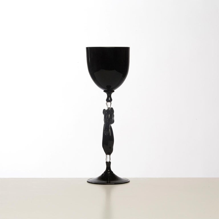 Exquisite set of 6 wine glasses handcrafted in Murano by the famous Venetian glass master Dario Frare. Executed using the traditional blowing technique, these are elegant pieces in signature glossy black glass, achieved thanks to its working with