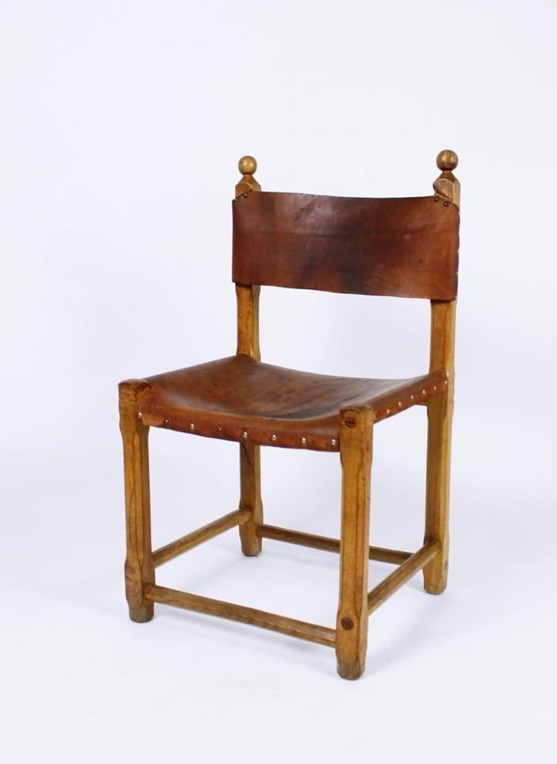 Stunning Hungarian handcrafted dining chairs . Made of oak and riveted thick cow-hide leather. Wear consistent with age and use.