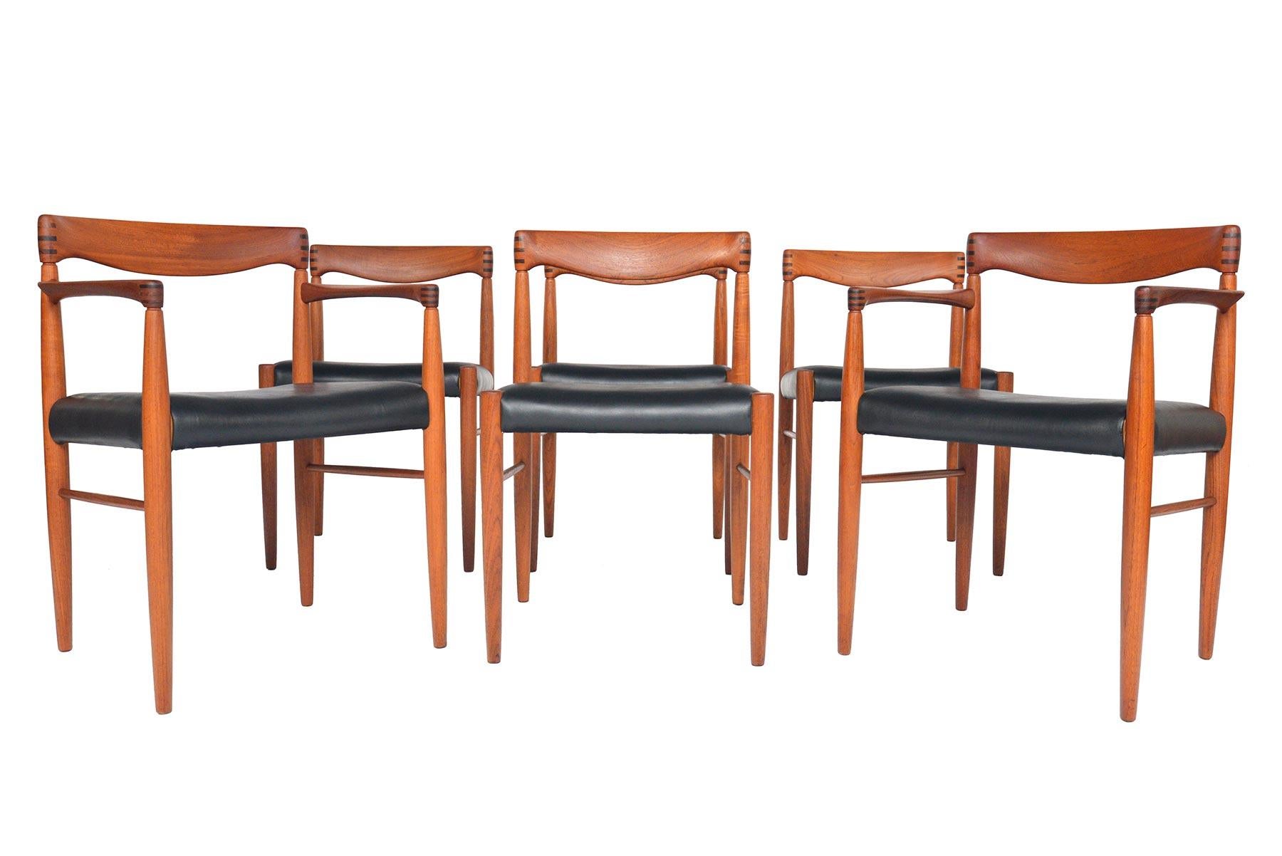 Sculpted to perfection, this set of six Danish modern teak and rosewood dining chairs was designed by H.W. Klein for Bramin in the 1960s. This original set includes two armed captain’s chairs and four side chairs. Bent teak backrests are adorned