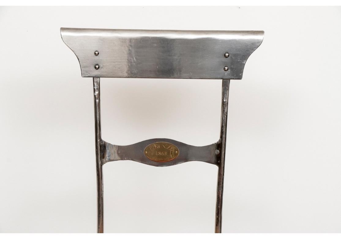 Set of six steel frame side chairs with woven rush seats. The chairs are comfortable and quite solid feeling. Each chair bears an oval brass plaque on the front and back of the central back splat saying, Firenze 1863/ Domani Ltd.” Very well made