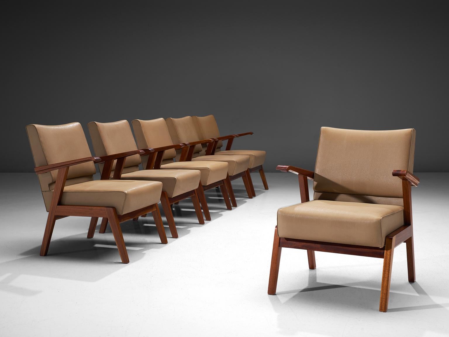 Easy chairs, in brown beige faux-leather and mahogany, Italy, 1950s. 

These mid-modern armchairs are executed in a neutral, natural beige colored leatherette. The comfortable easy chairs show voluptuous, round lines. The most iconic feature of