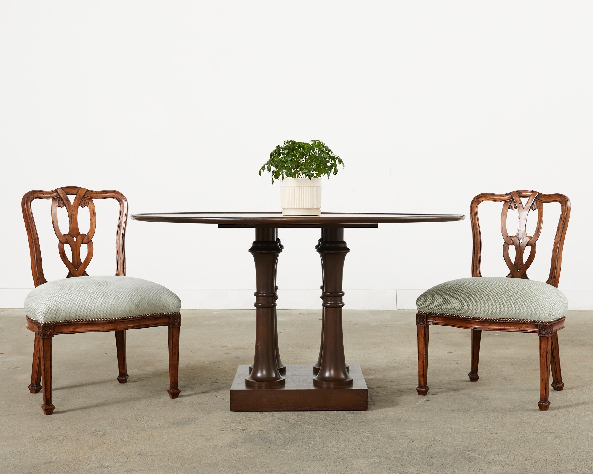 Distinctive set of six Italian dining chairs crafted in the Chippendale taste. The carved walnut frames feature a Venetian style ribbon back. The matching chairs are upholstered with two different, but complementary geometric fabrics having