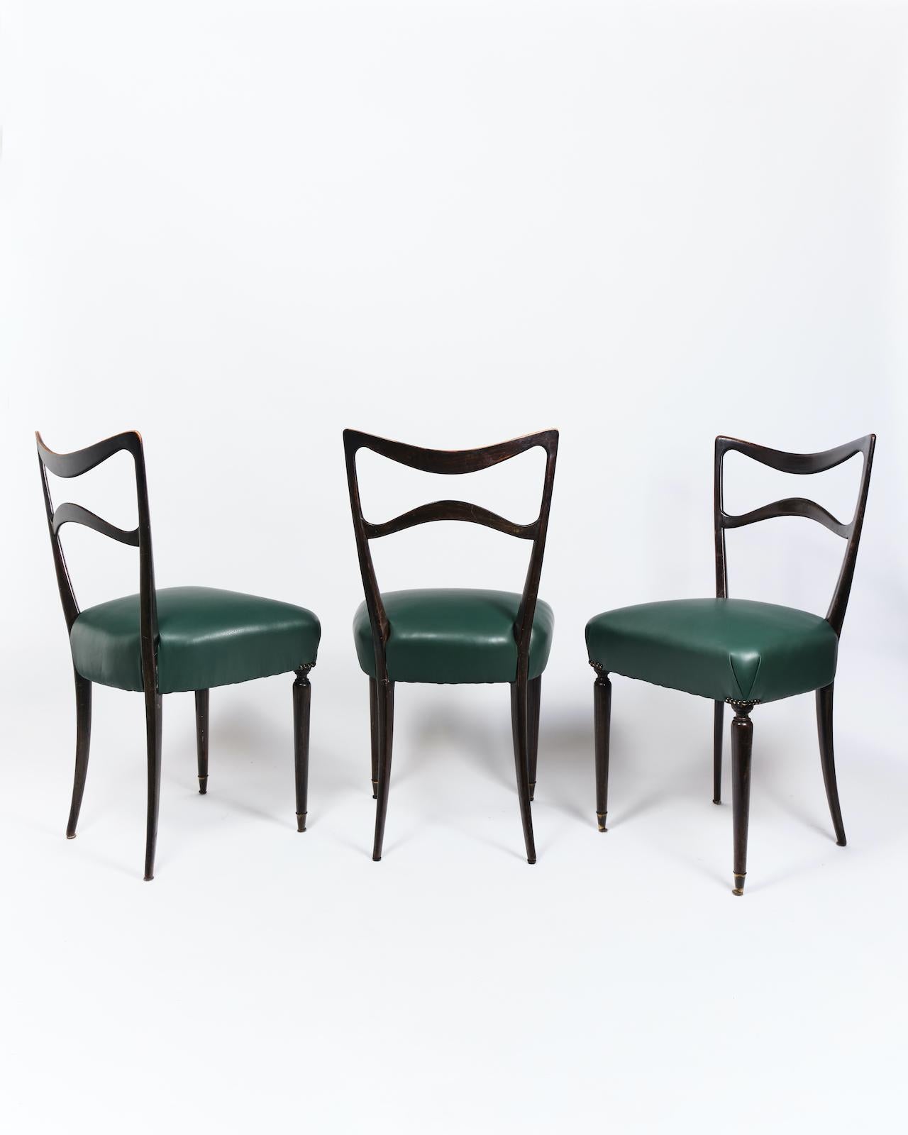 Set of six Italian mid-century modern dining chairs, designed circa 1950. 

The chairs are presented in stained wood with new upholstery in turquoise and supported by brass feet. 
