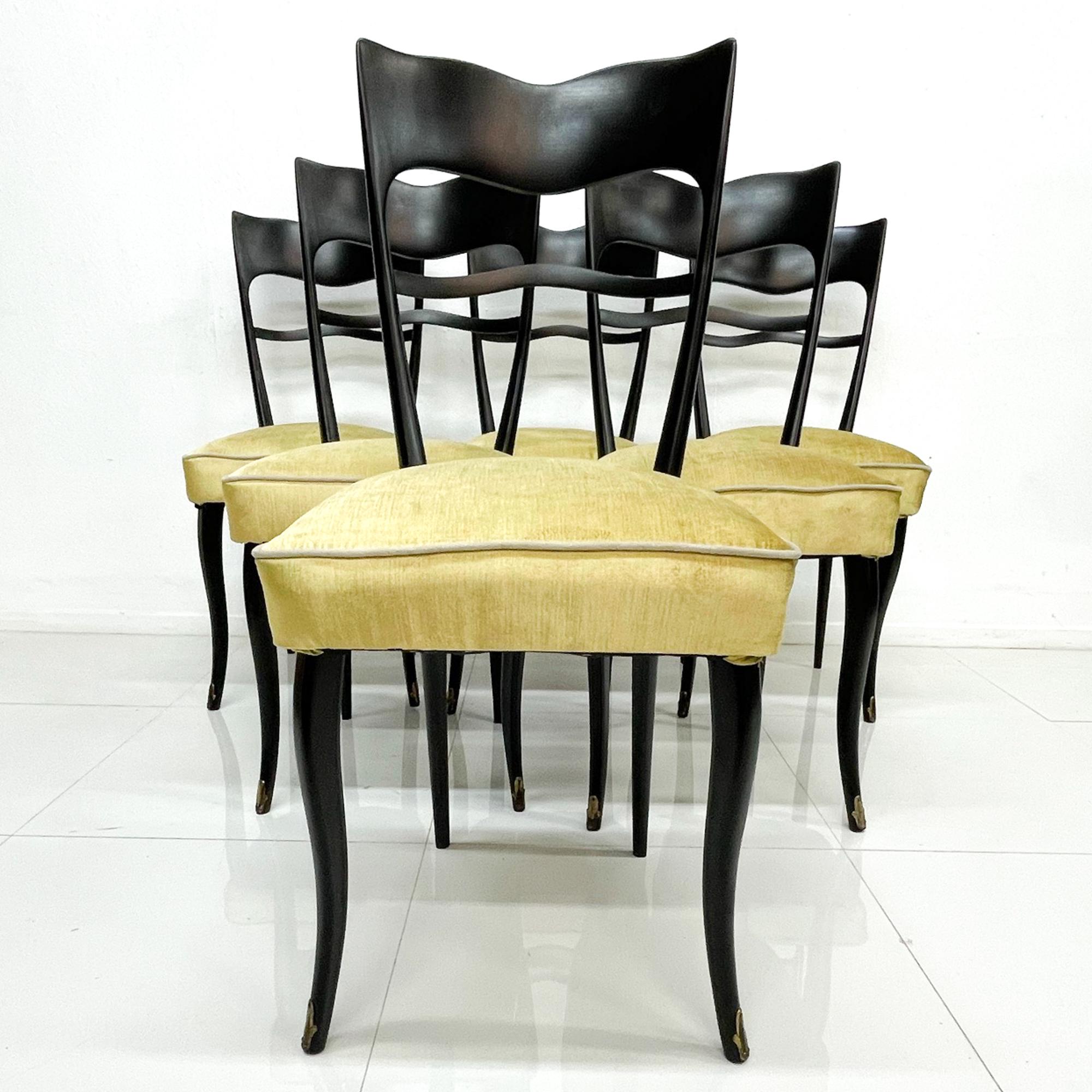 For your consideration a set of six (6) Italian dining chairs. Sculptural wooden chairs with elegant curved and clean modern lines. Wood has been restored to match the original specifications in black satin color. New upholstery in gold and silver.