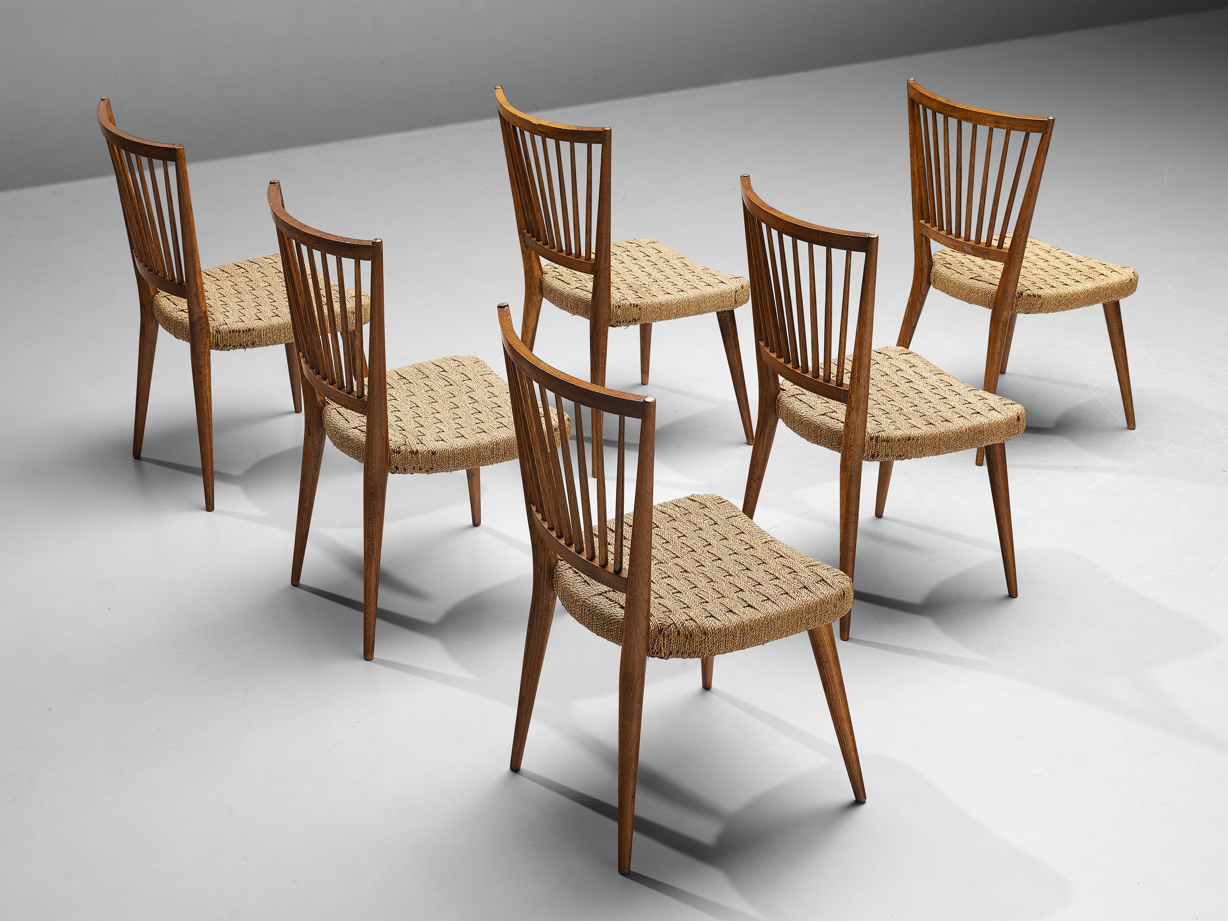 Set of six dining chairs, oak, wicker braided straw, Italy, 1950s

Delicate Italian dining chairs with comfortable seats in wicker straw braided in a geometric pattern. Four tapered, circular legs lift the seat up. Lovely detail is the trapezoid