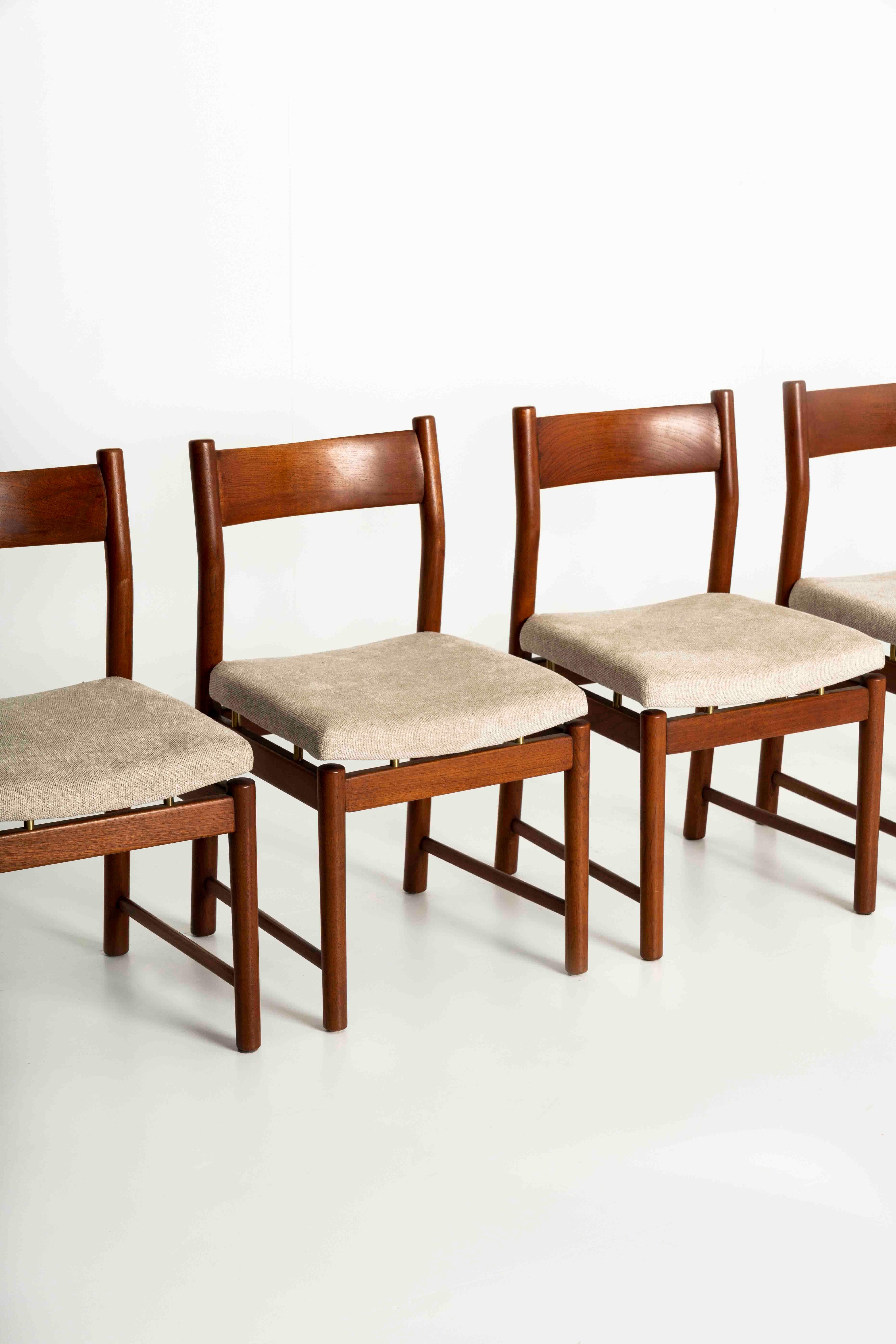 Set of six dining room chairs by Ilmari Tapiovaara for La Permanente Cantù Italy, the 1950s. The chairs have a solid wood teak structure with brass details under the seating area. The seating area is newly upholstered in an attractive off-white