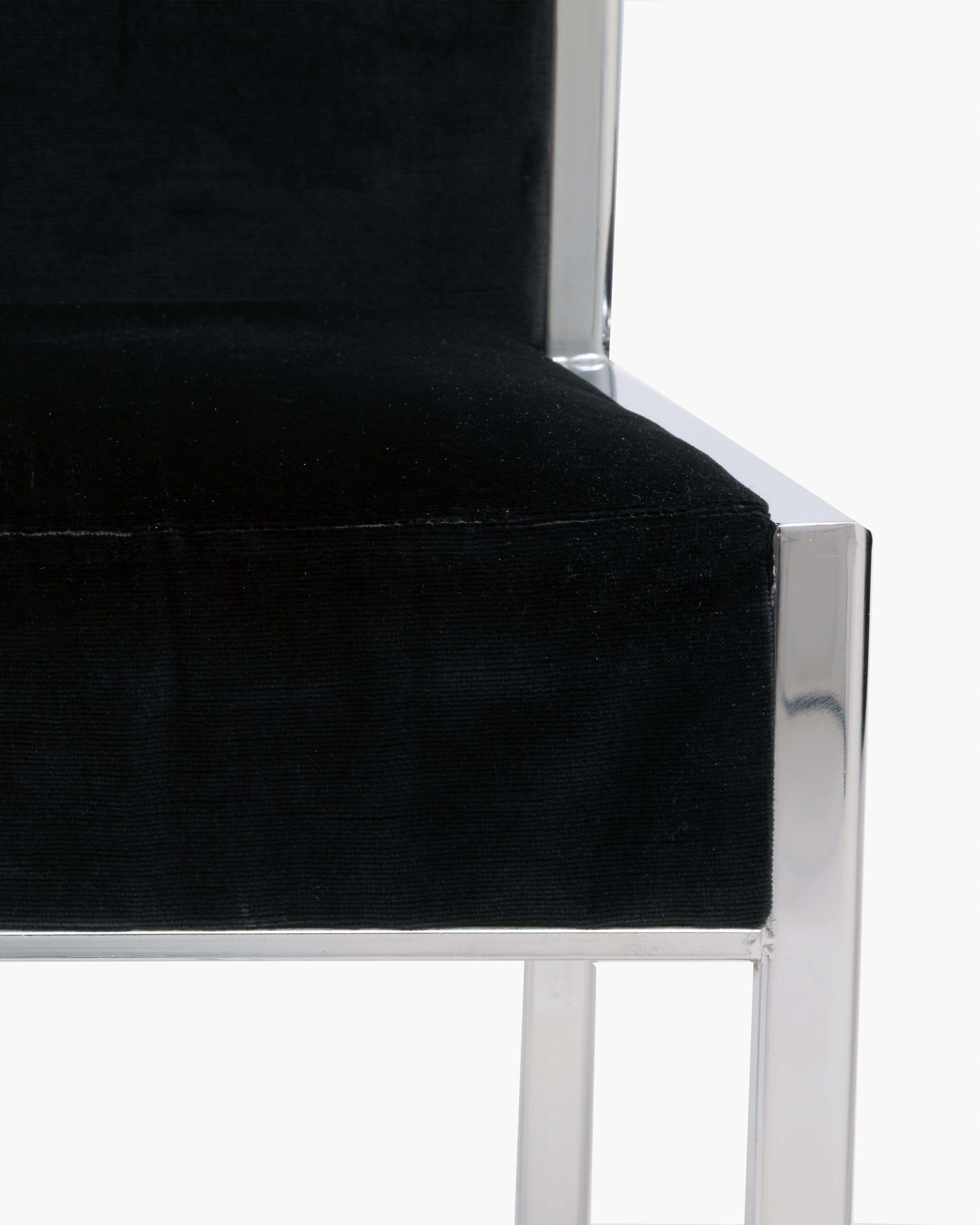 A set of six high-backed dining chairs, each made with a solid chrome frame. These chairs possess an elegant sophistication; their beautiful, simple design, high curved back, and black velvet upholstery provide a clean yet rich look for any dining