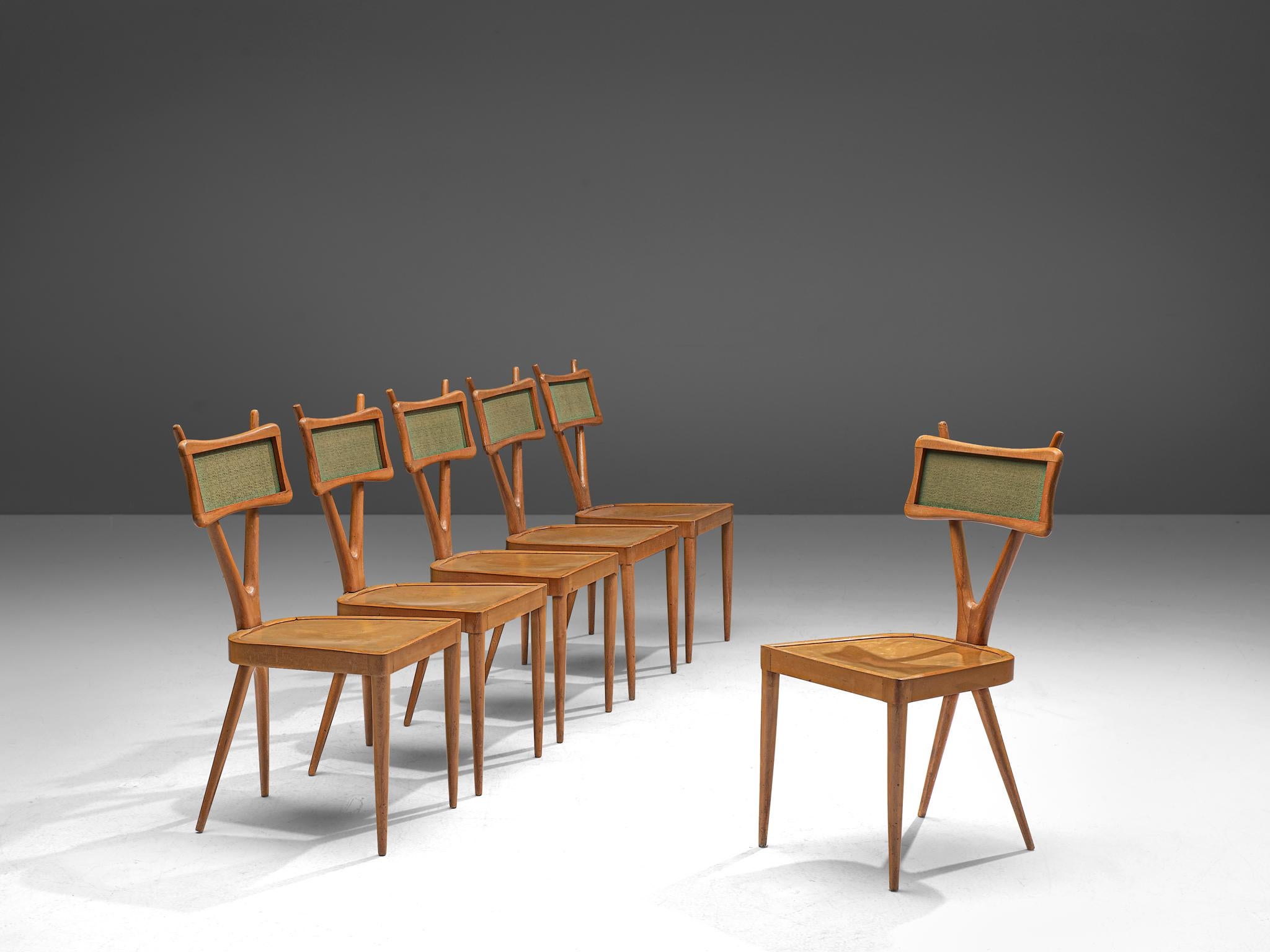 Set of 6 dining chairs, beech and plywood, Italy, 1950s.

Set of 6 Italian dining chairs with characteristic X-shaped backrests. The model is also playful due to the crossed back and green colored backrest. The chairs feature conical tapered legs,