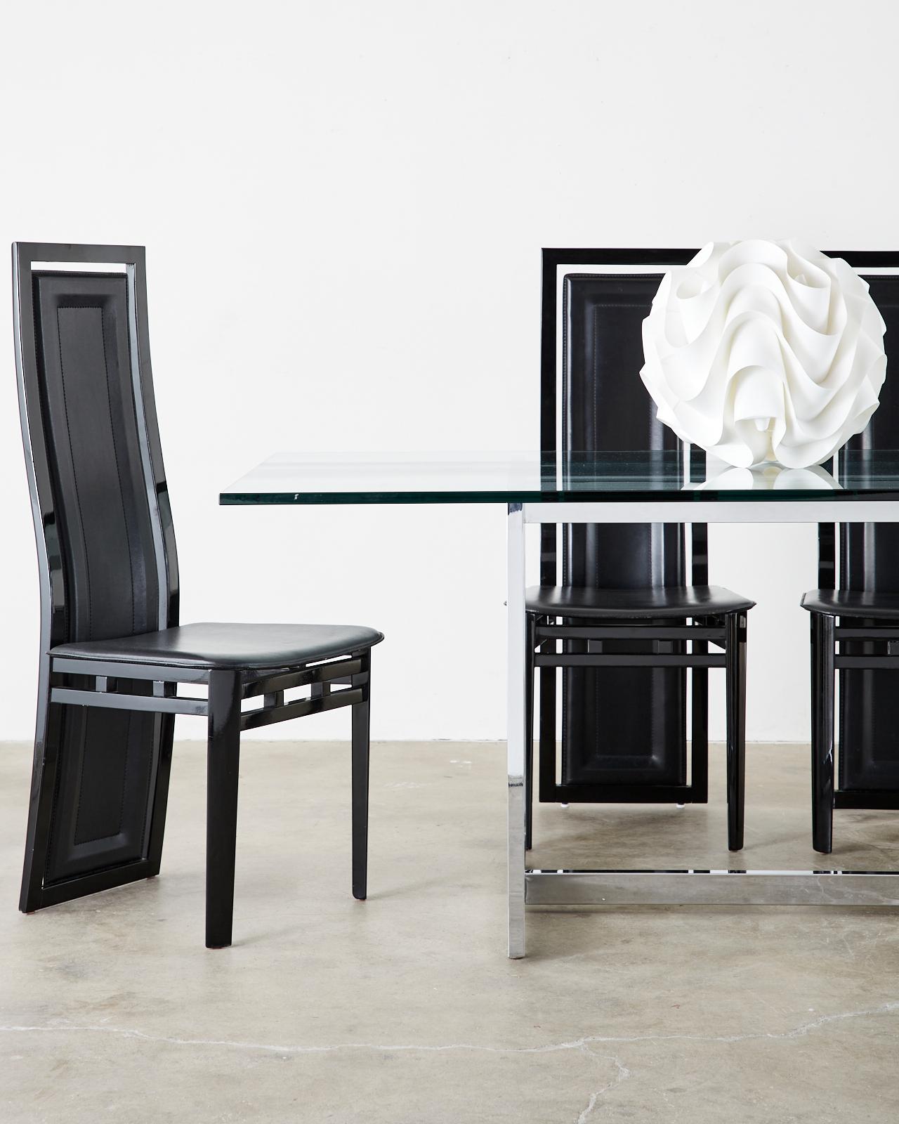 Sculptural set of six Postmodern dining chairs designed by Antonio Sibau in Manzano, Italy. Features lacquered wood frames with gracefully curved backs supporting a large leather padded back splat. The creative design allows the leather back to flex