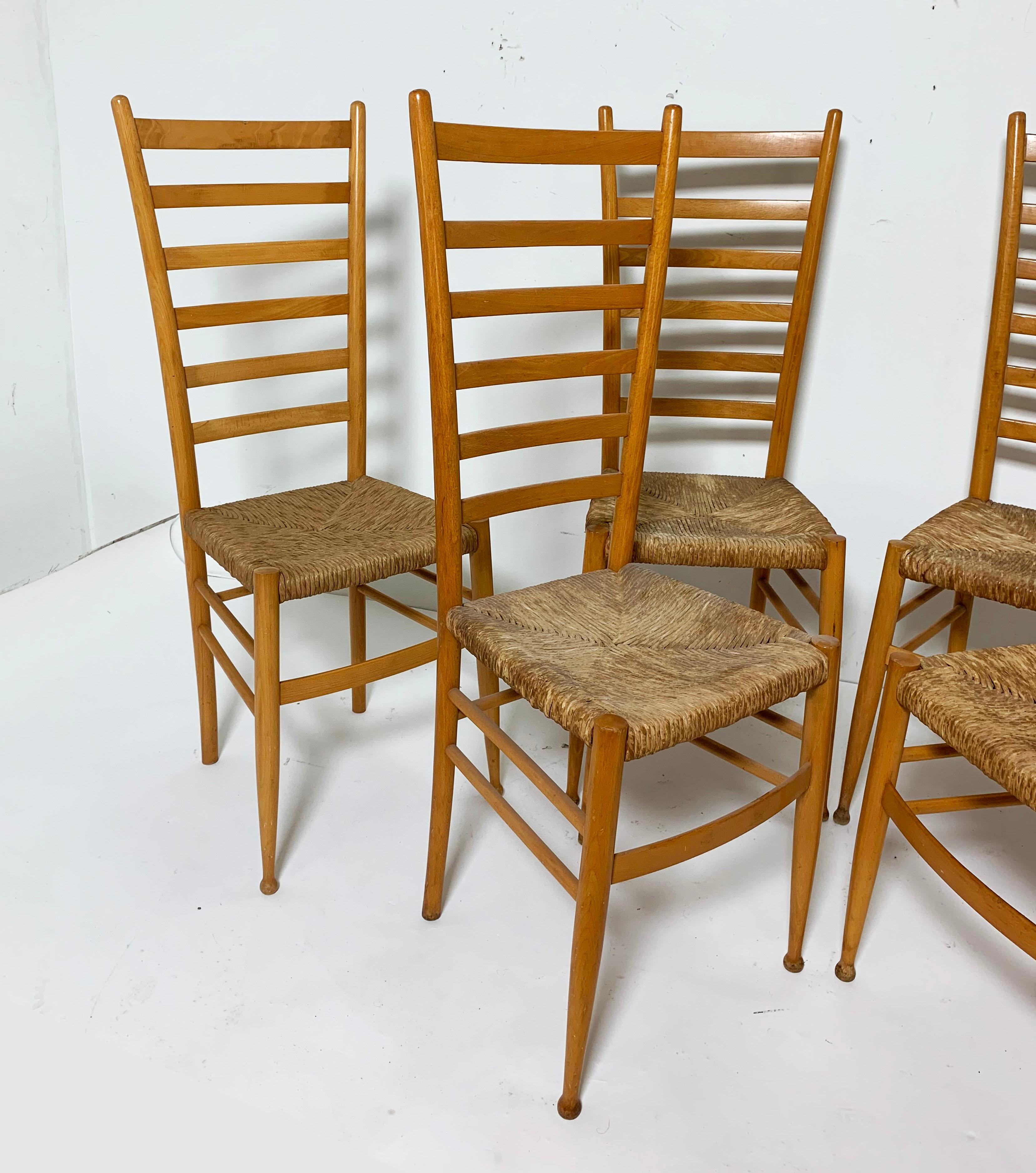 Set of six Italian ladder back dining chairs with woven rush seats in the manner of Gio Ponti, imported in the 1960s from the Chiavari region by Otto Gerdau.