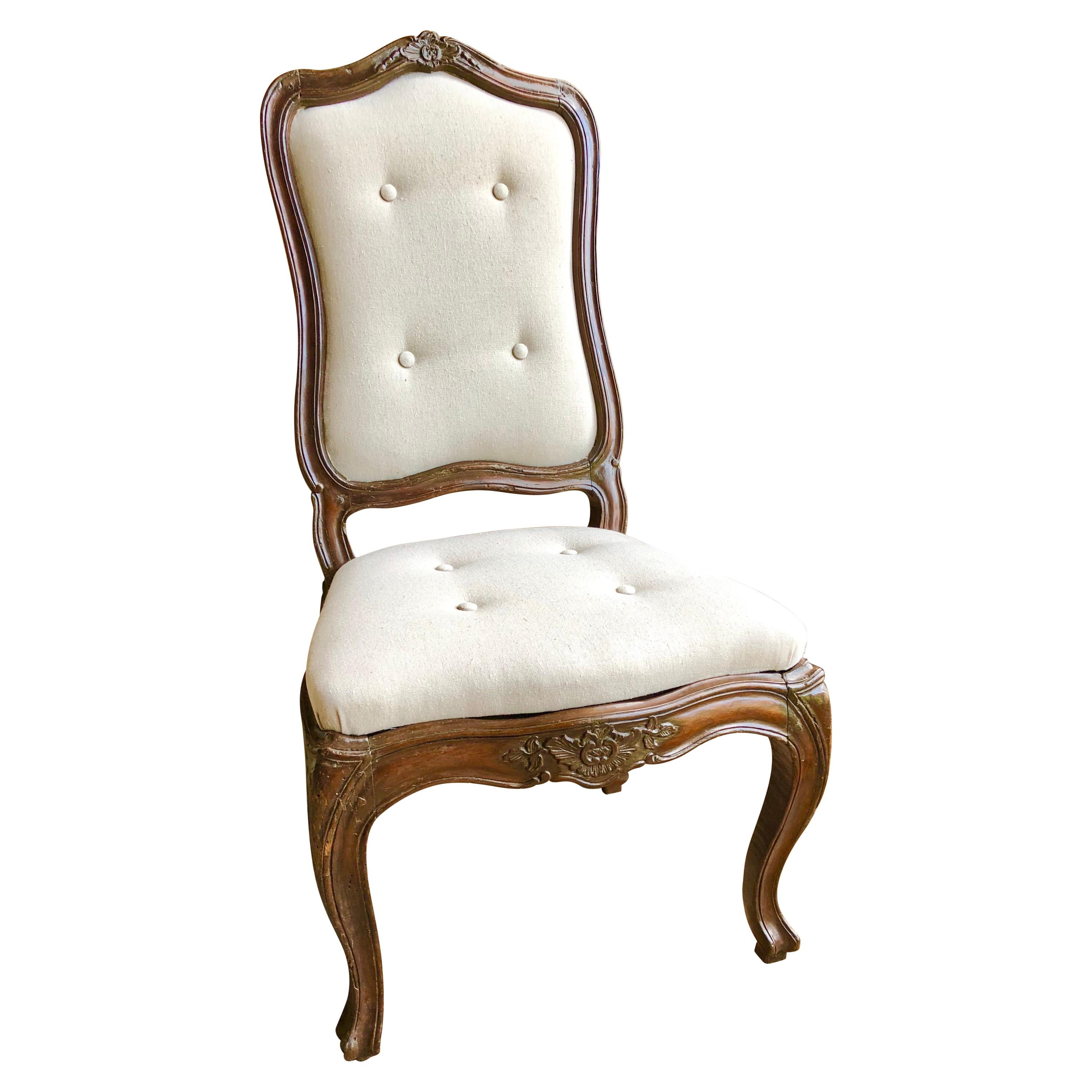 A nice set of 6 Italian dining chairs in walnut, early 19th century, in the Louis XV manner, with slip seats and backs, newly upholstered in wheat-colored cotton duck with buttons. The frames have carvings on the seat rails and top crests and are