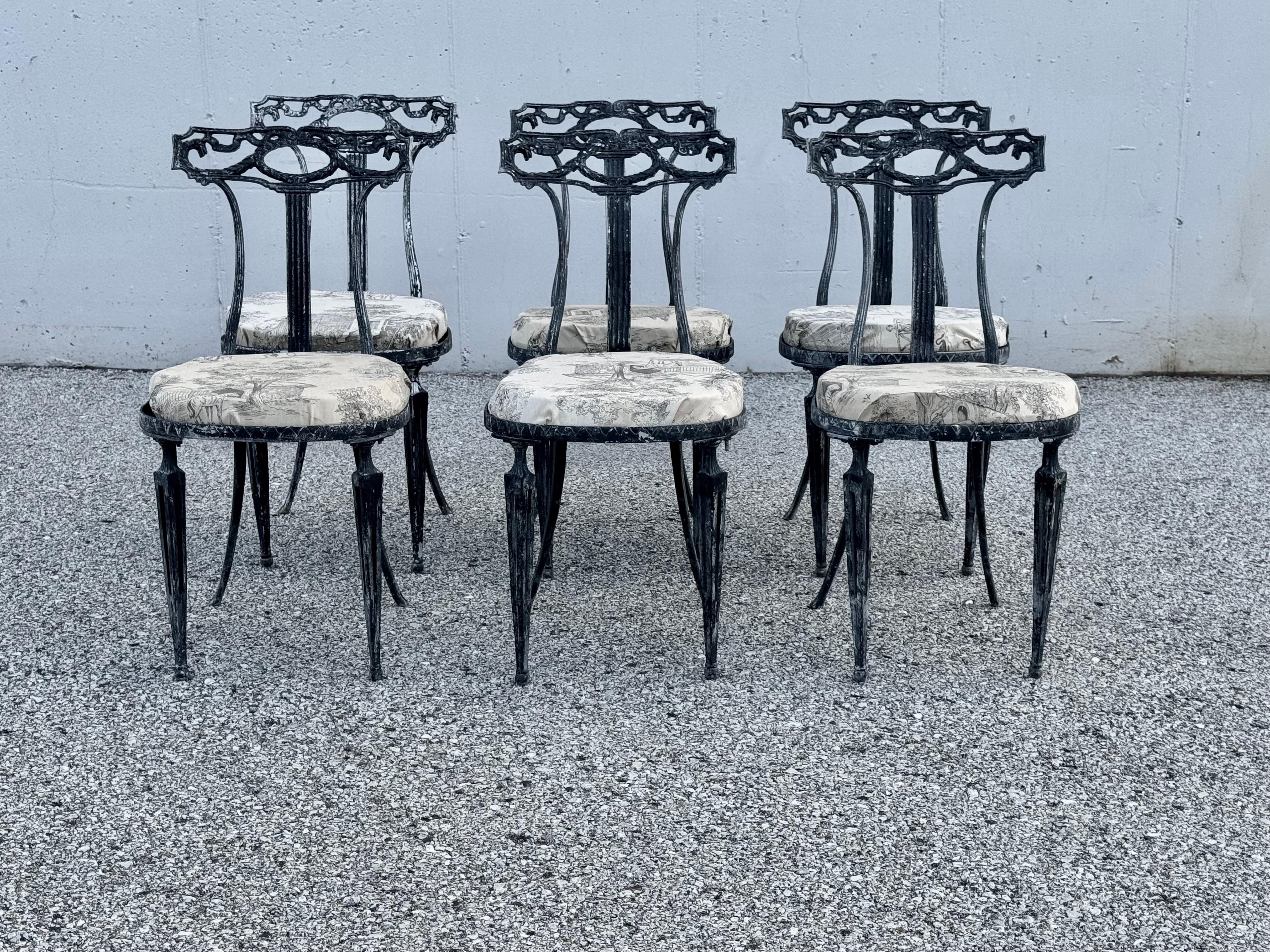 Set of six Italian Neo-Classical style or Hollywood Regency designed dinning side chairs by Palladio. Originally painted creme with gilt accents. Previous owner had them stripped, and painted black to use as outdoor patio chairs. The cushions, need