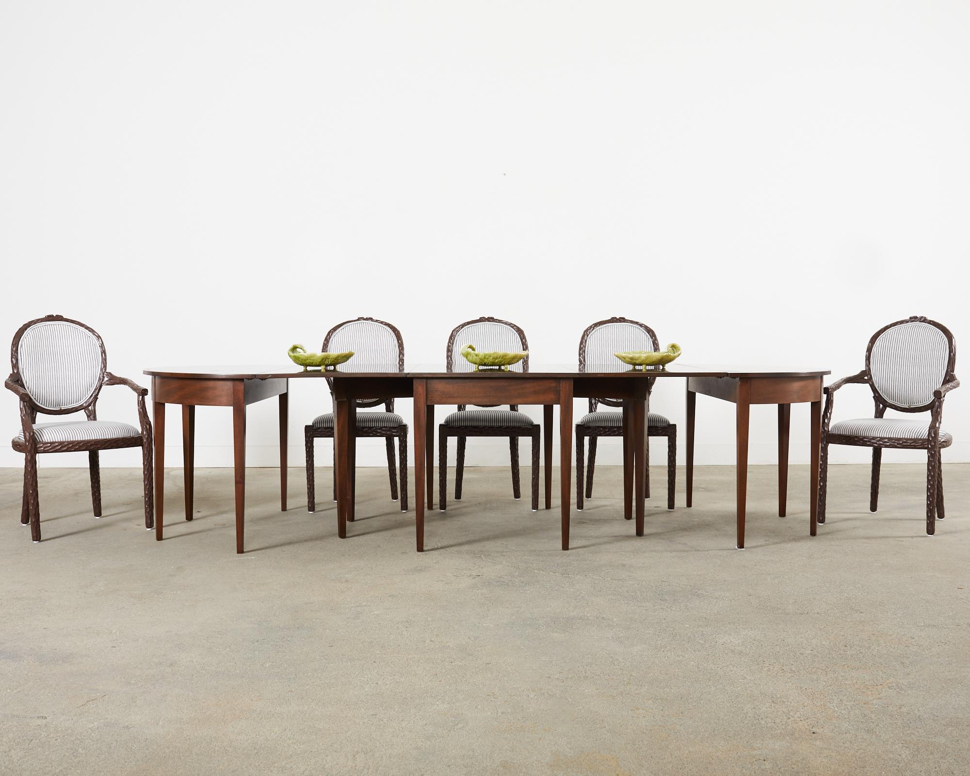 Handsome set of six mid-century modern Italian regency style dining chairs featuring a hand-carved faux bois twig finish on the frames. The carved frames are lacquered in a rich, dark espresso color. The set consists of 4 side chairs and 2 host