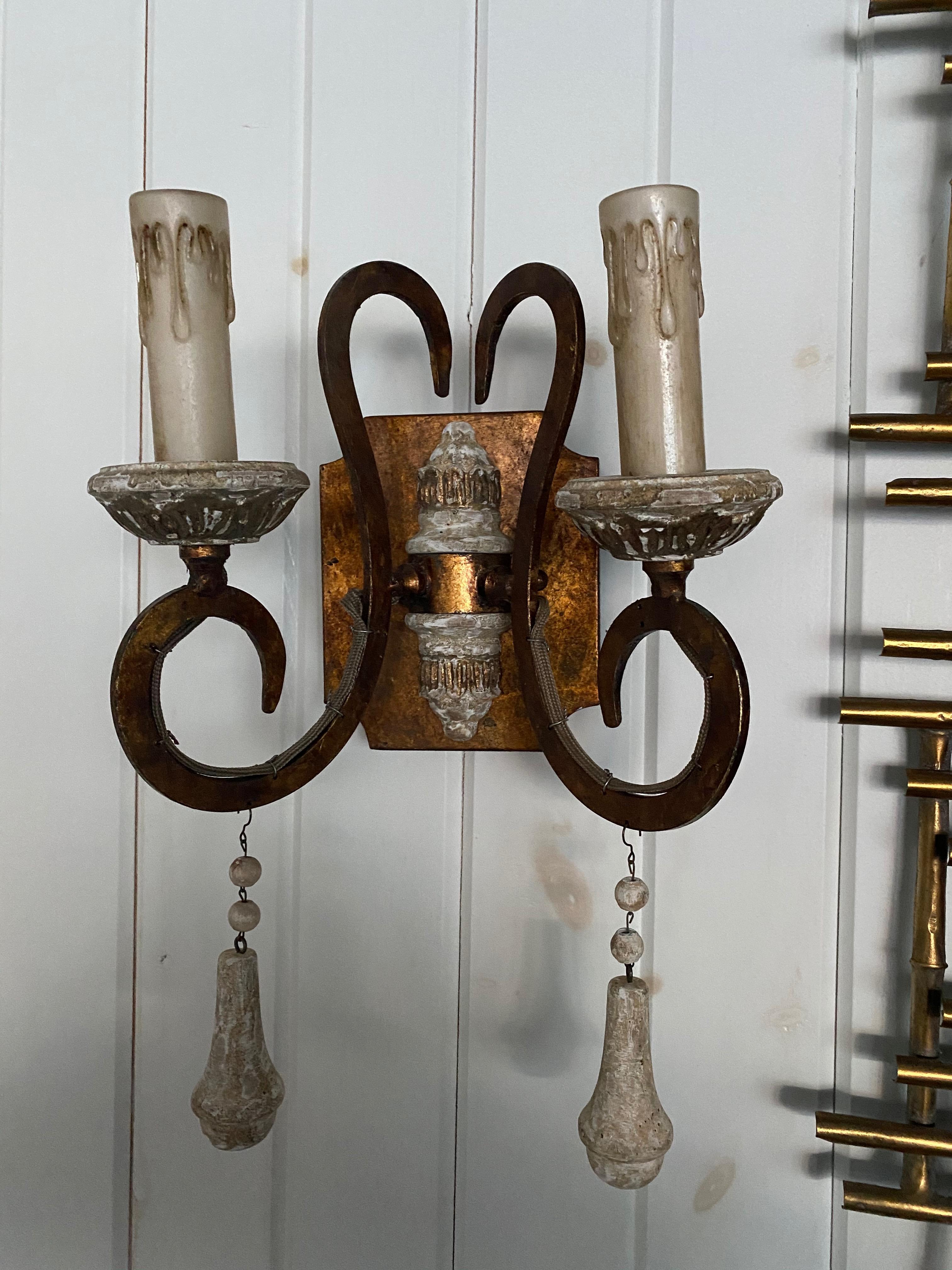 Set of six Italian style tole and carved wood two-arm sconces with wood drops. Lovely worn patina. Newly wired and ready for installation. Priced per sconce.