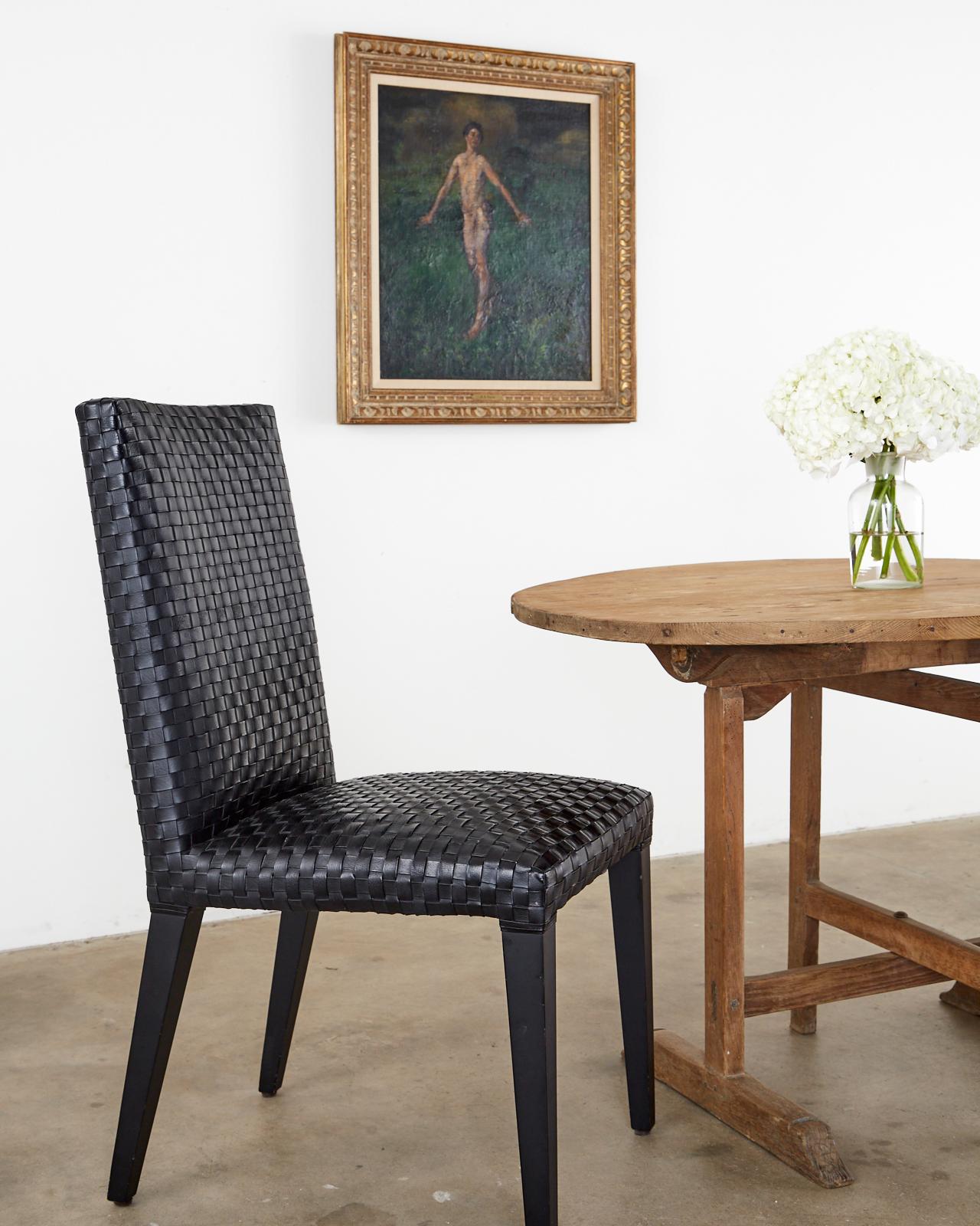 Stylish set of six modern Italian dining chairs featuring a woven or braided black leather upholstery. Beautifully crafted from hardwood frames with an ebonized finish and covered with a leather strap style upholstery. Supported by tapered legs the