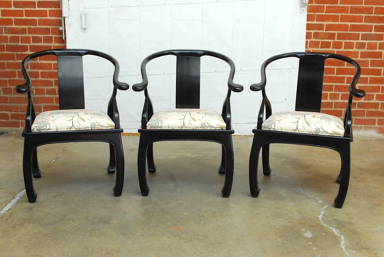 Fabulous set of six Mid-Century Modern horseshoe chairs by Bernhardt Furniture Company. Made in the manner and style of James Mont featuring a black lacquered finish. Shaped chow style legs with a beautiful updated upholstery featuring floral and