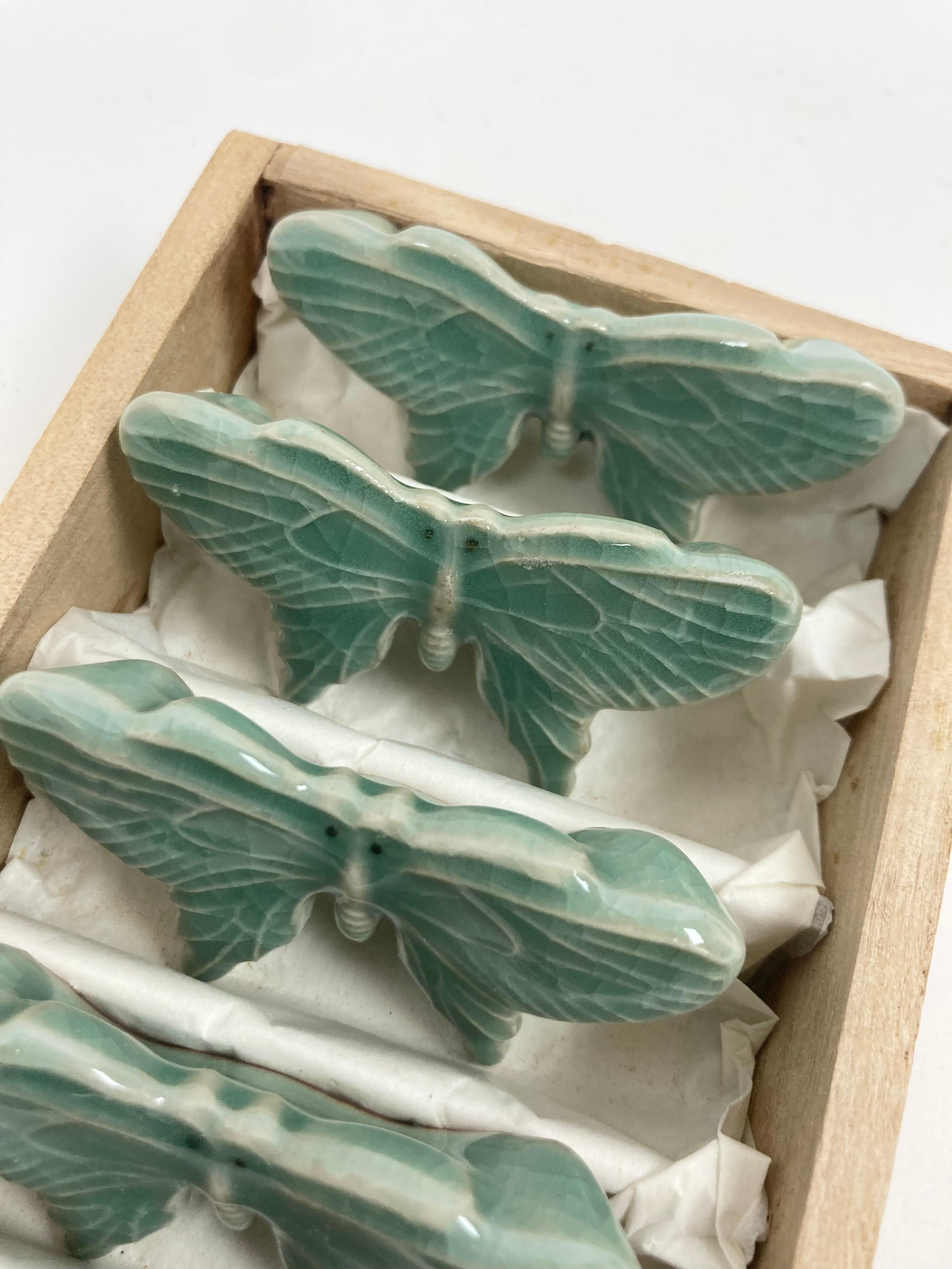 A colorful and fine set of Six Japanese Glazed Pottery Chop Stick Rests in Butterfly Form.  The color is a deep Celadon and the Butterflies, with open wings, have fine incised line inlay details on the wings with two tiny black dots at the head.