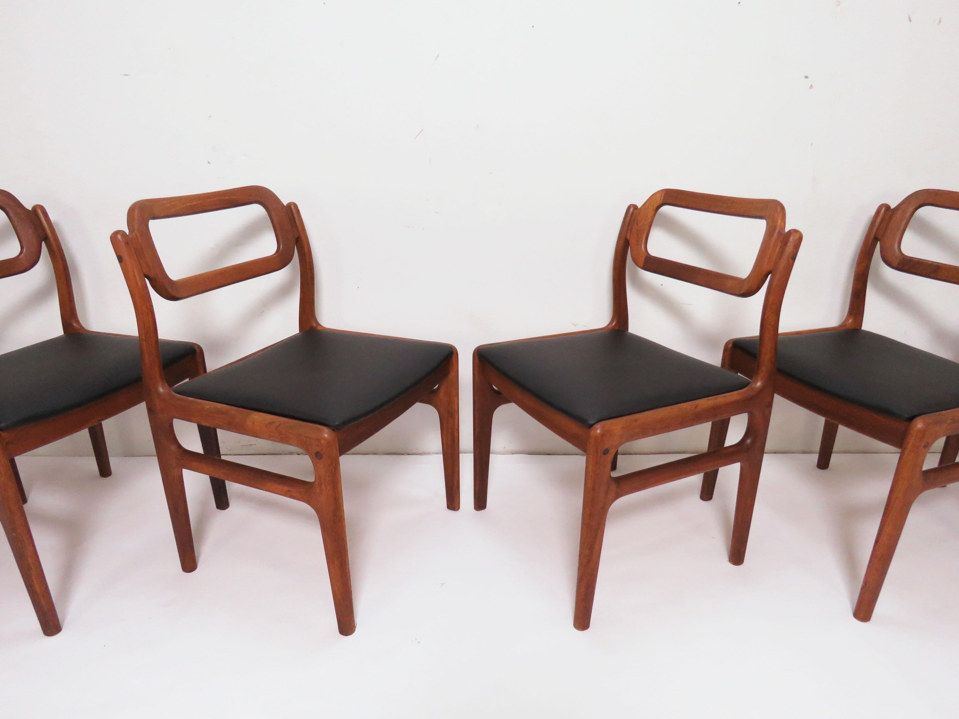 Set of six sculptural carved teak open back dining chairs by Johannes Andersen for Uldum Mobelfabrik, Denmark, circa 1960s.