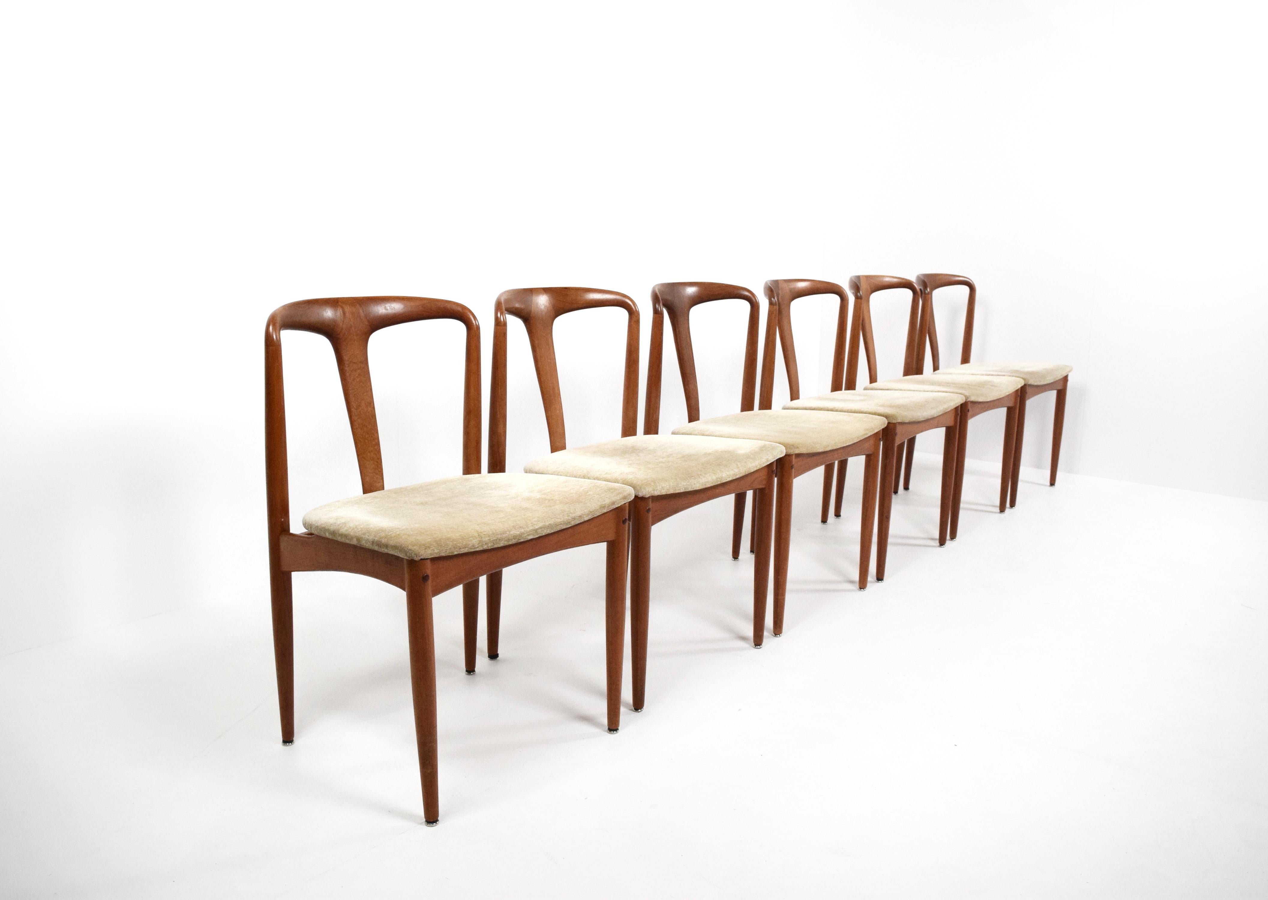 Set of Six Johannes Andersen 'Juliane' Dining Chairs for Uldum Møbelfabrik from Denmark 1960's. These chairs in teak have a timeless design and are in original condition with the original fabric. The curved shapes make make it a light and elegant