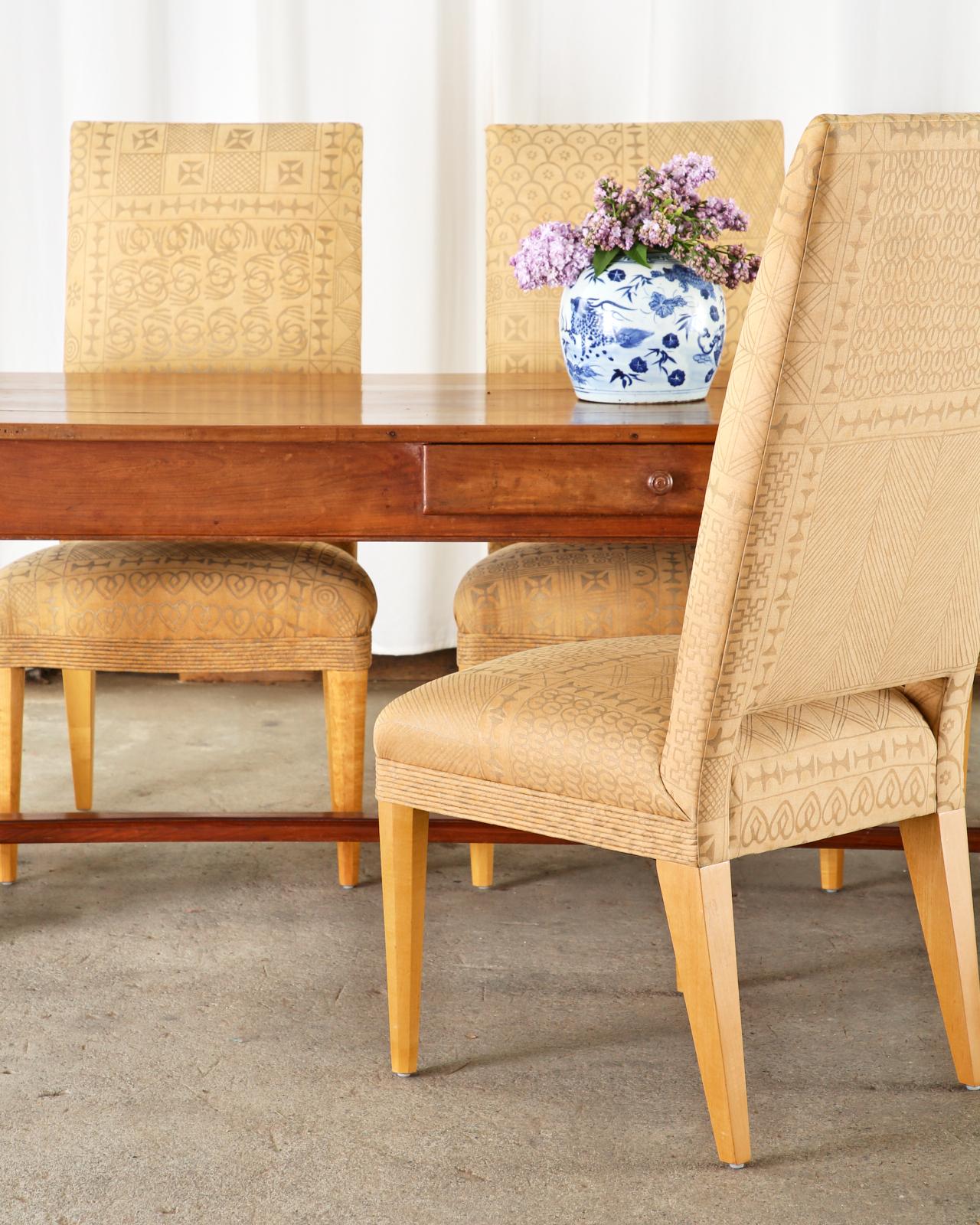 Fantastic set of six dining chairs designed by John Hutton for Donghia. Bespoke chairs custom ordered with Fortuny upholstery in the Ashanti tribal pattern from Venice, Italy. The chairs feature a hardwood frame having a tall flat back that is open