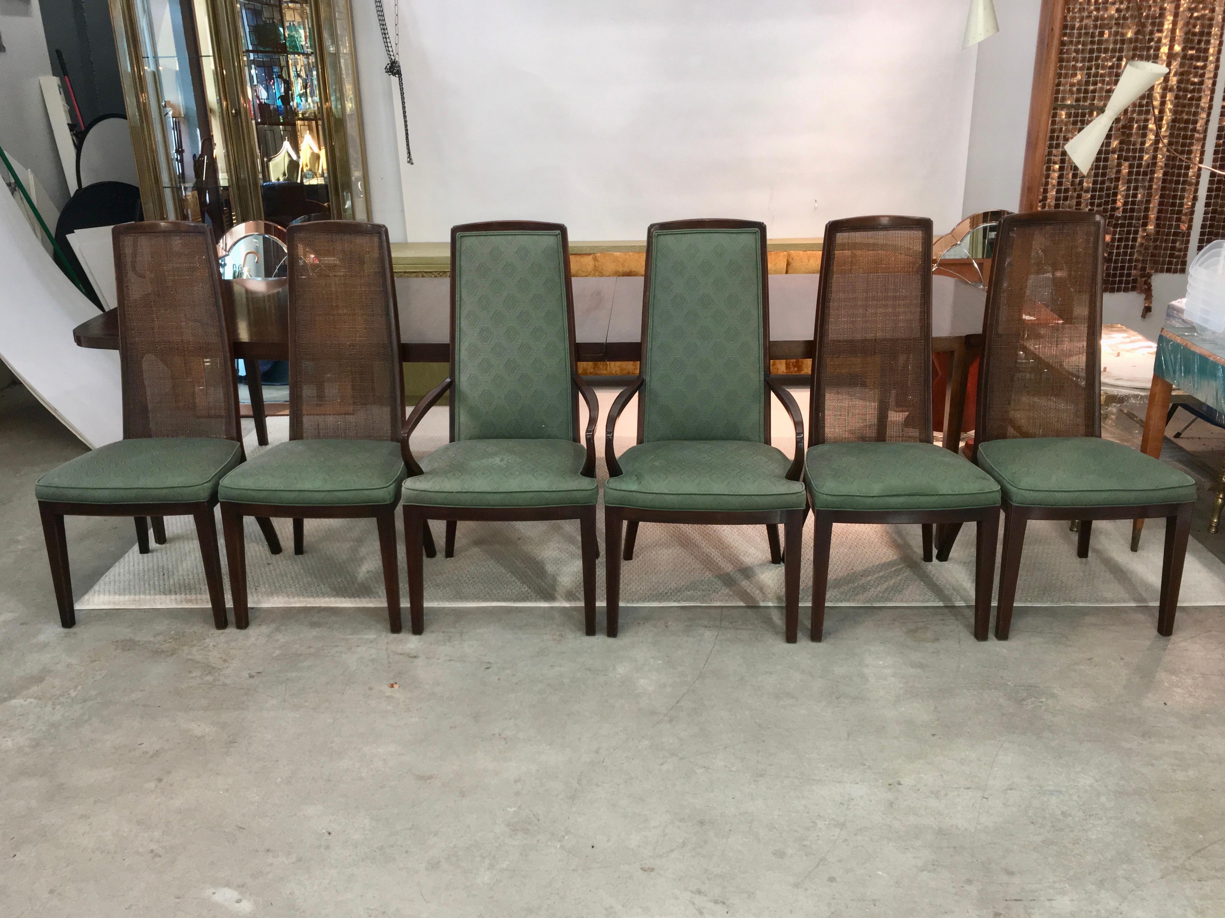 Set of six walnut dining chairs by John Widdicomb, circa 1960. The four side chairs have woven radio cane backs. The two arm chairs have upholstered backs which match the seats. See our separate listing ref: LU886616072242 for the matching dining